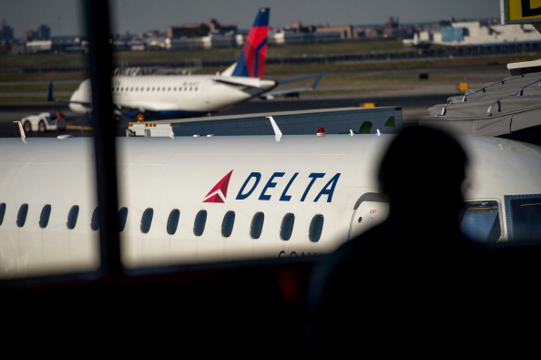 The silhouette of a passenger waiting for a flight is seen in the Delta Air Lines Inc. terminal at LaGuardia Airport in New York on Oct. 21, 2013. (Bloomberg via Getty Images)