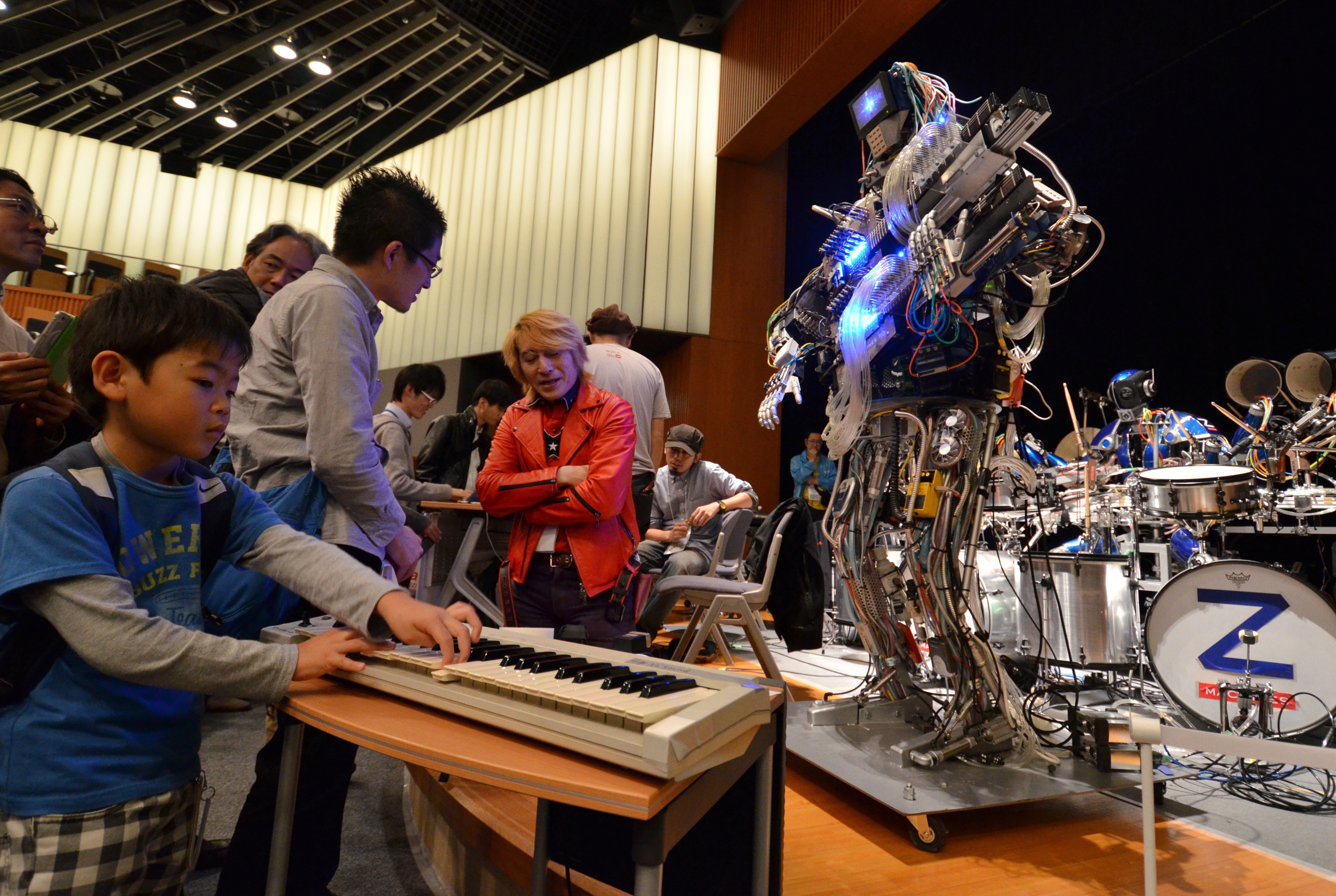 A boy plays a keyboard to control robot guitarist "Mach", a member of a robot rock band "Z-Machines", during the two day art and technology event "Maker Faire Tokyo" at the National Museum of Emerging Science and Innovation in Tokyo on November 3, 2013. (YOSHIKAZU TSUNO&mdash;AFP/Getty Images)