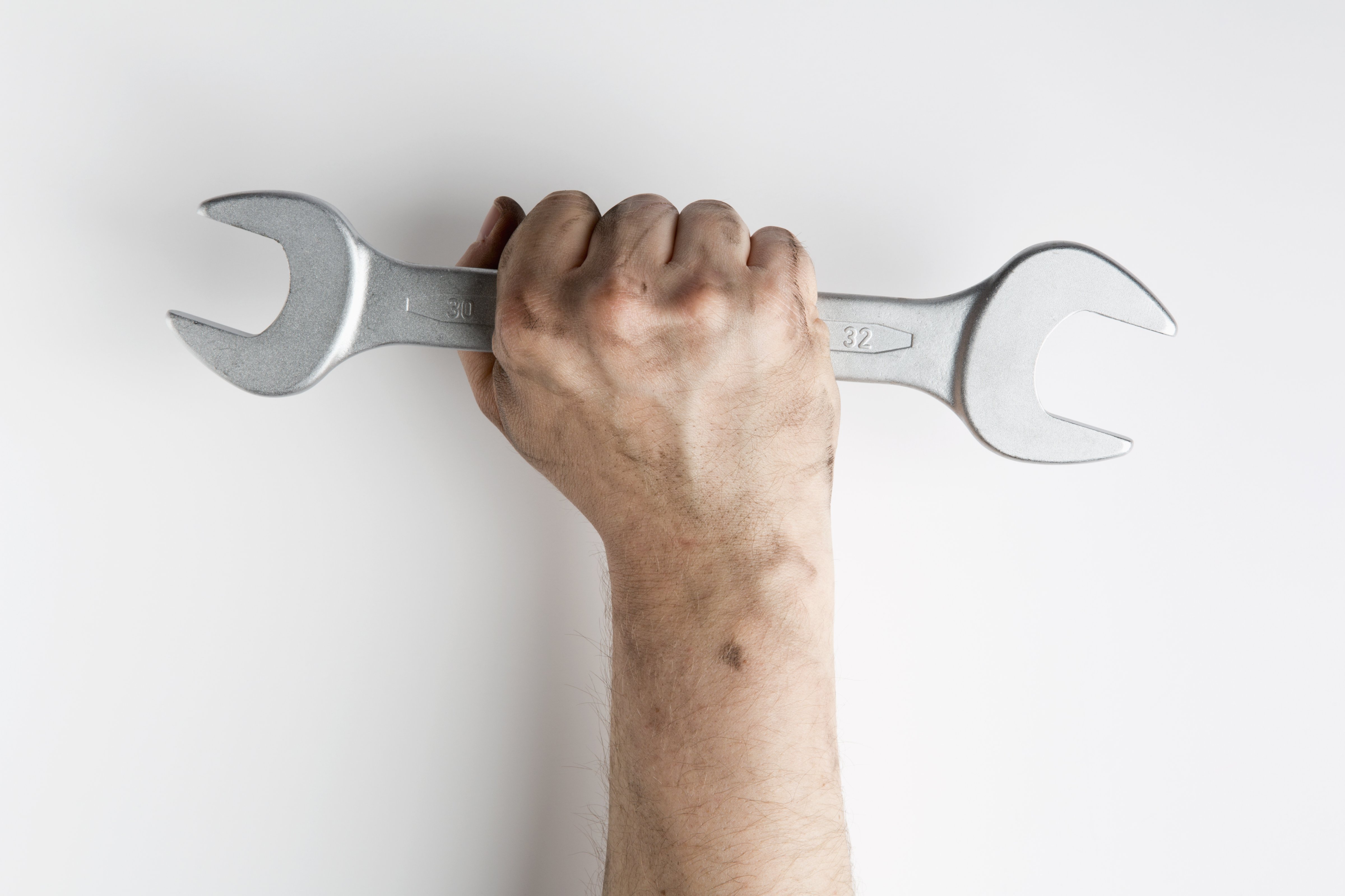 A fist holding a wrench up triumphantly (Caspar Benson—Getty Images/fStop)