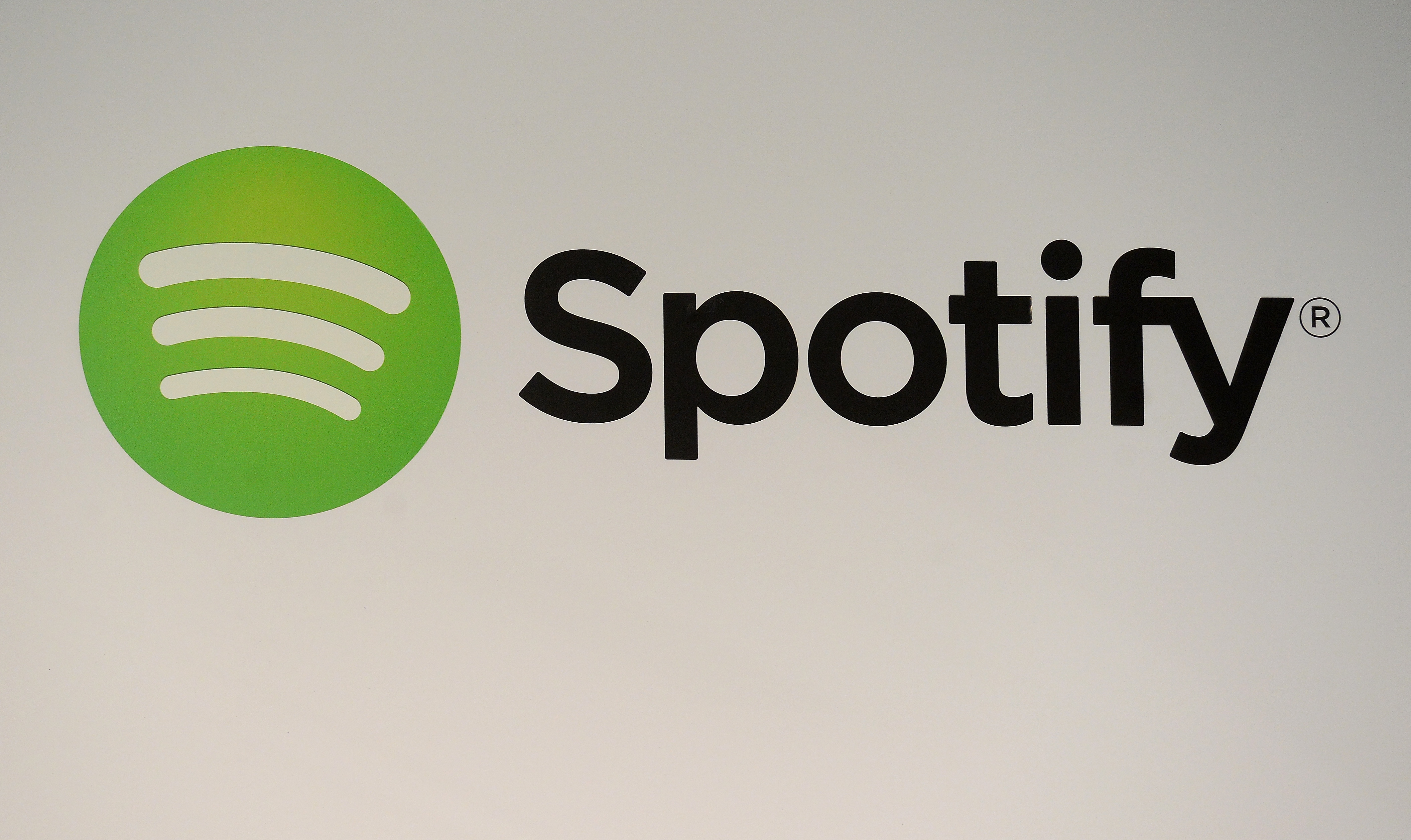 A Spotify logo is seen as founder and CEO Daniel Ek addresses a press conference in New York, December 11, 2013. (Emmanuel Dunand—AFP/Getty Images)