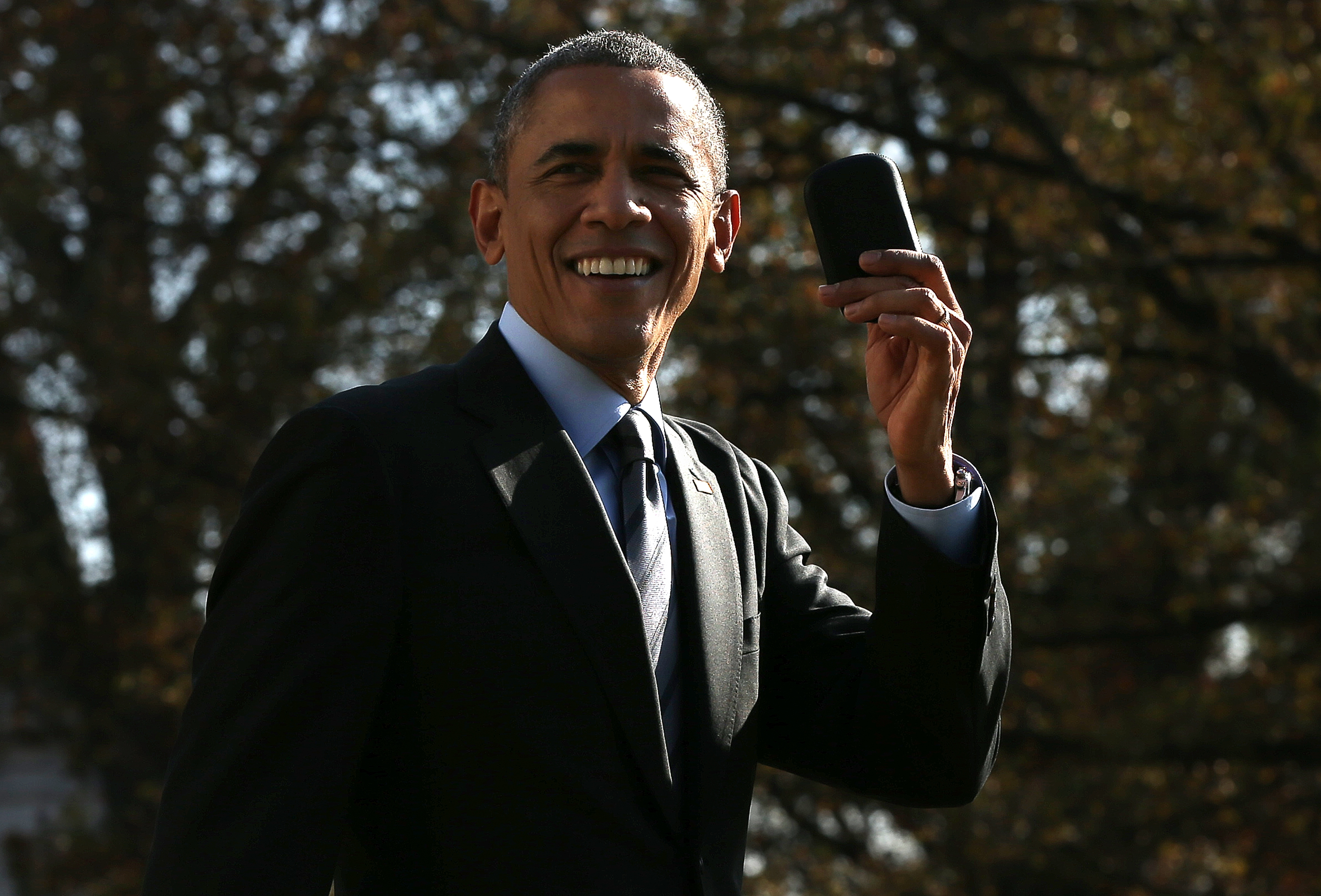 U.S. President Barack Obama holds up his Blackberry after he ran back into the White House after forgetting the mobile phone while departing for a domestic trip November 21, 2014 in Washington, DC. (Win McNamee&mdash;Getty Images)