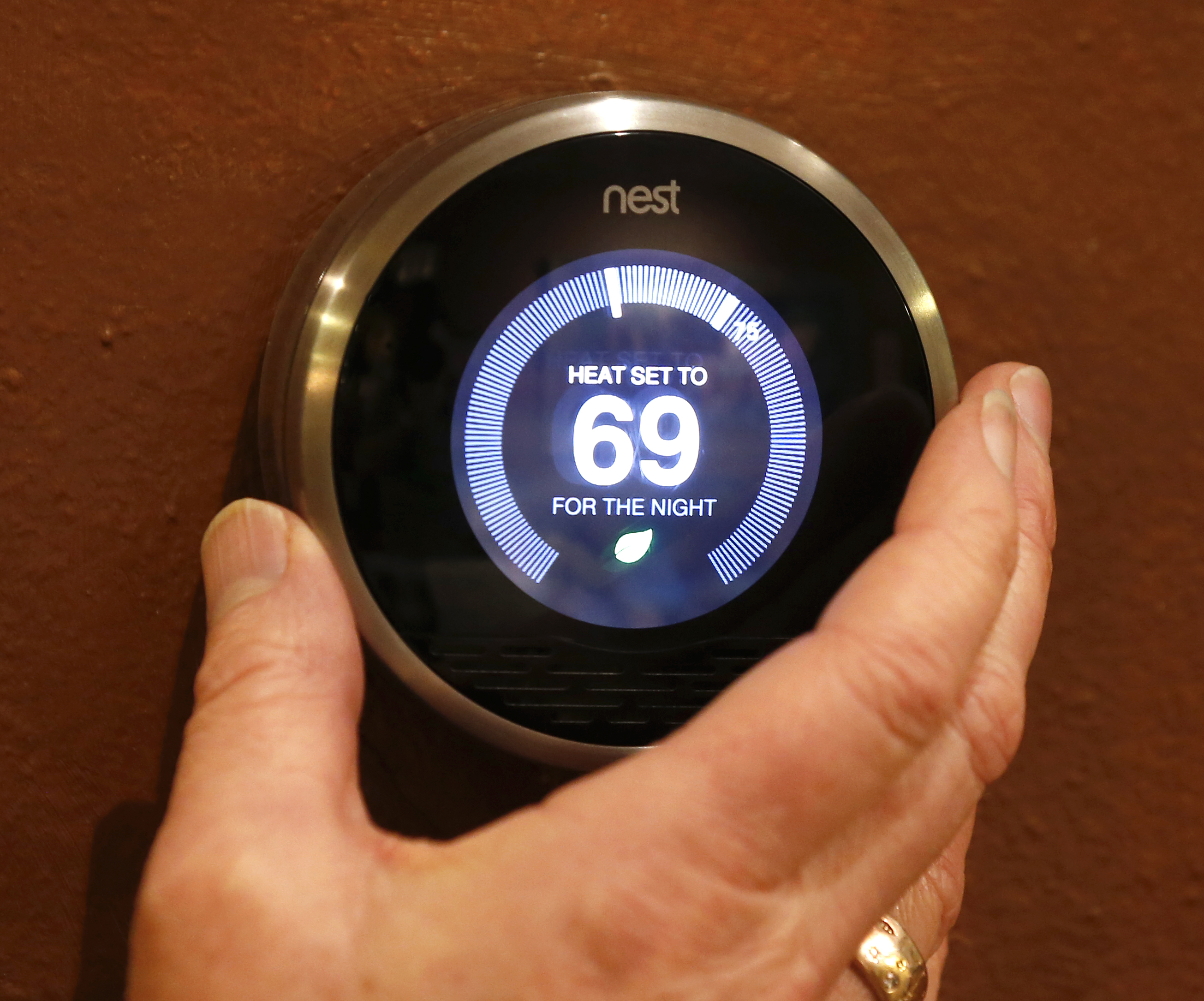 In this photo illustration, a Nest thermostat is being adjusted in a home on January 16, 2014 in Provo, Utah. (George Frey&mdash;Getty Images)