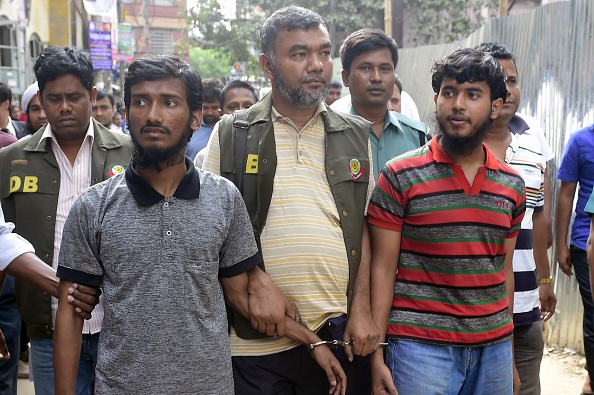 Bangladesh police escort two men accused in the murder of blogger Washiqur Rahman for a court appearance in Dhaka on March 31, 2015 (Munir uz ZAMAN—AFP/Getty Images)