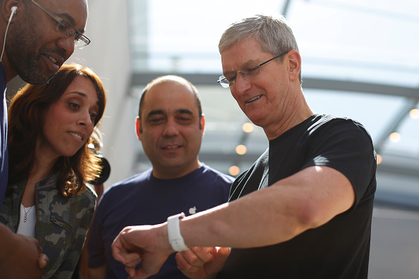 Apple CEO Tim Cook displays his personal Apple Watch to customers at an Apple Store on April 10, 2015, in Palo Alto, Calif. (Stephen Lam—Getty Images)