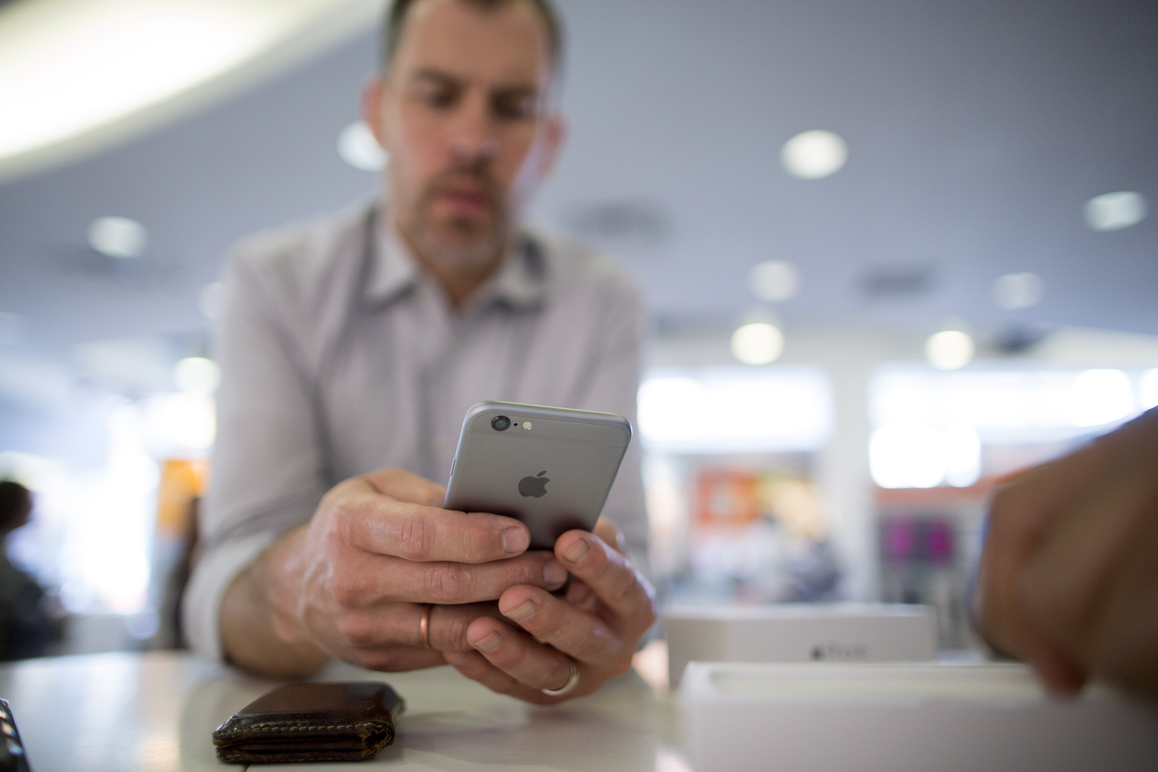 Retail sales consultant Ahmal Warner, right, helps customer Joel Nelson set up his new Apple Inc. iPhone 6 at an AT&amp;T store in Washington, D.C., U.S., on Tuesday, April 21, 2015. (Andrew Harrer&mdash;© 2015 Bloomberg Finance LP)