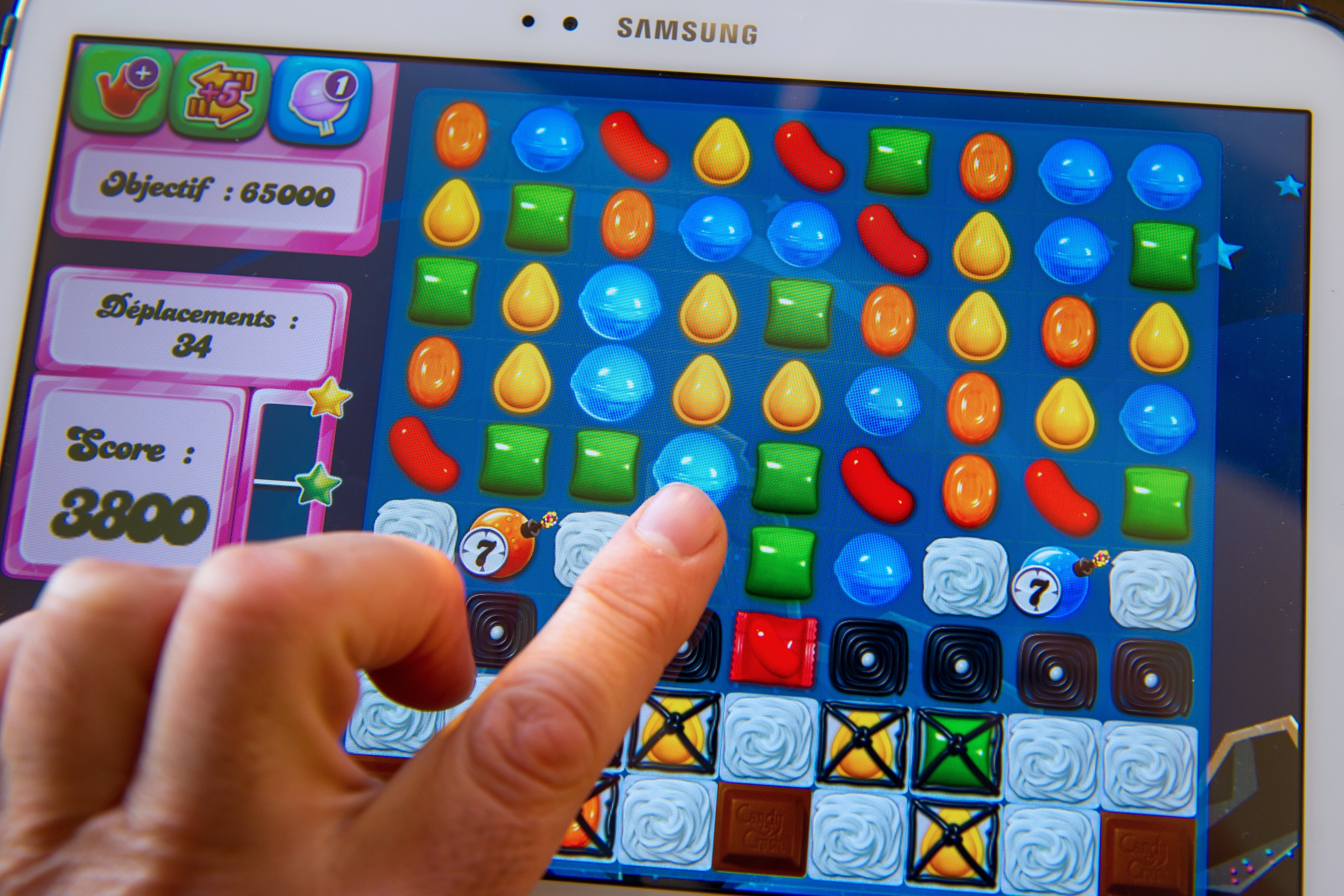 A person plays on his tablet with Candy Crush Saga games developed by British King Digital Entertainment, on March 6, 2014, in Lille, northern France. (Philippe Huguen&mdash;AFP/Getty Images)