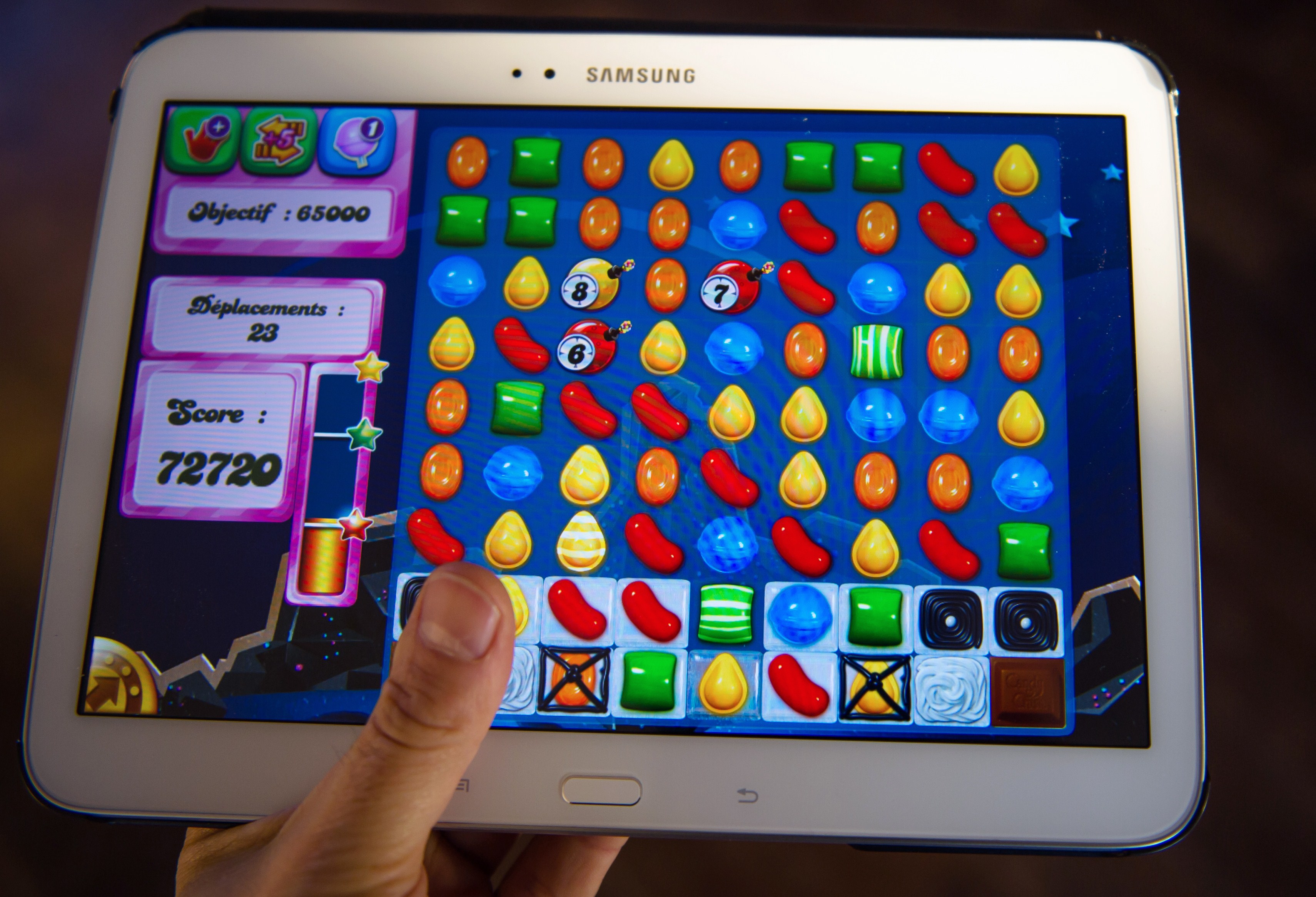 A person plays on his tablet with Candy Crush Saga games developed by British King Digital Entertainment, on March 6, 2014, in Lille, northern France. (Philippe Huguen—AFP/Getty Images)