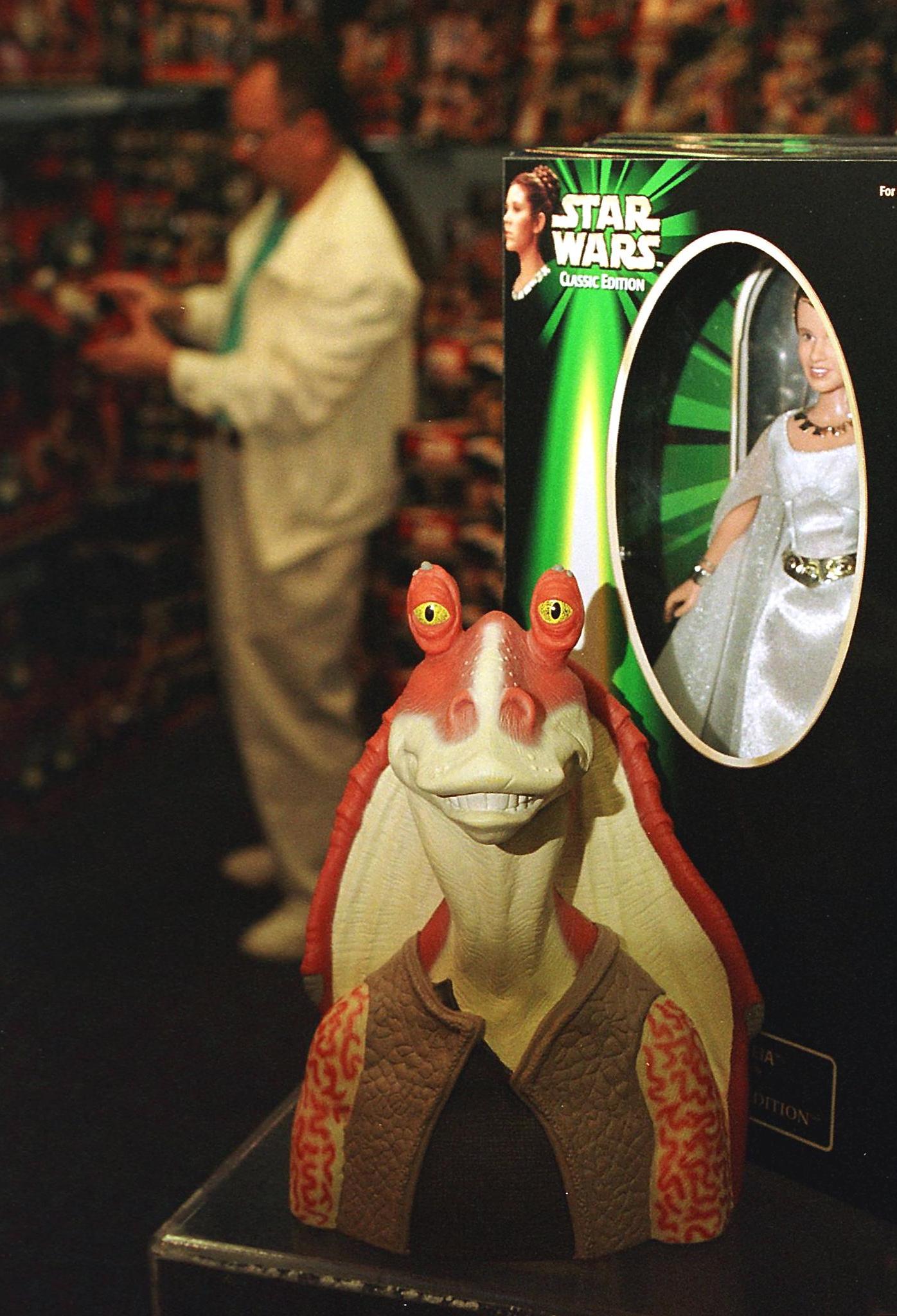 A figure of the character called Jar Jar Binks (C) from the Star Wars movie The Phantom Menace sits next to a figure of Princess Leia (R) from the original Star Wars trilogy in a display at FAO Schwartz 07 May 1999 in Garden City, NY. (MATT CAMPBELL—AFP/Getty Images)