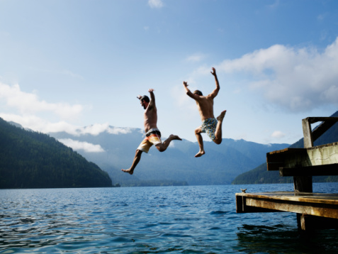 men-jumping-into-water