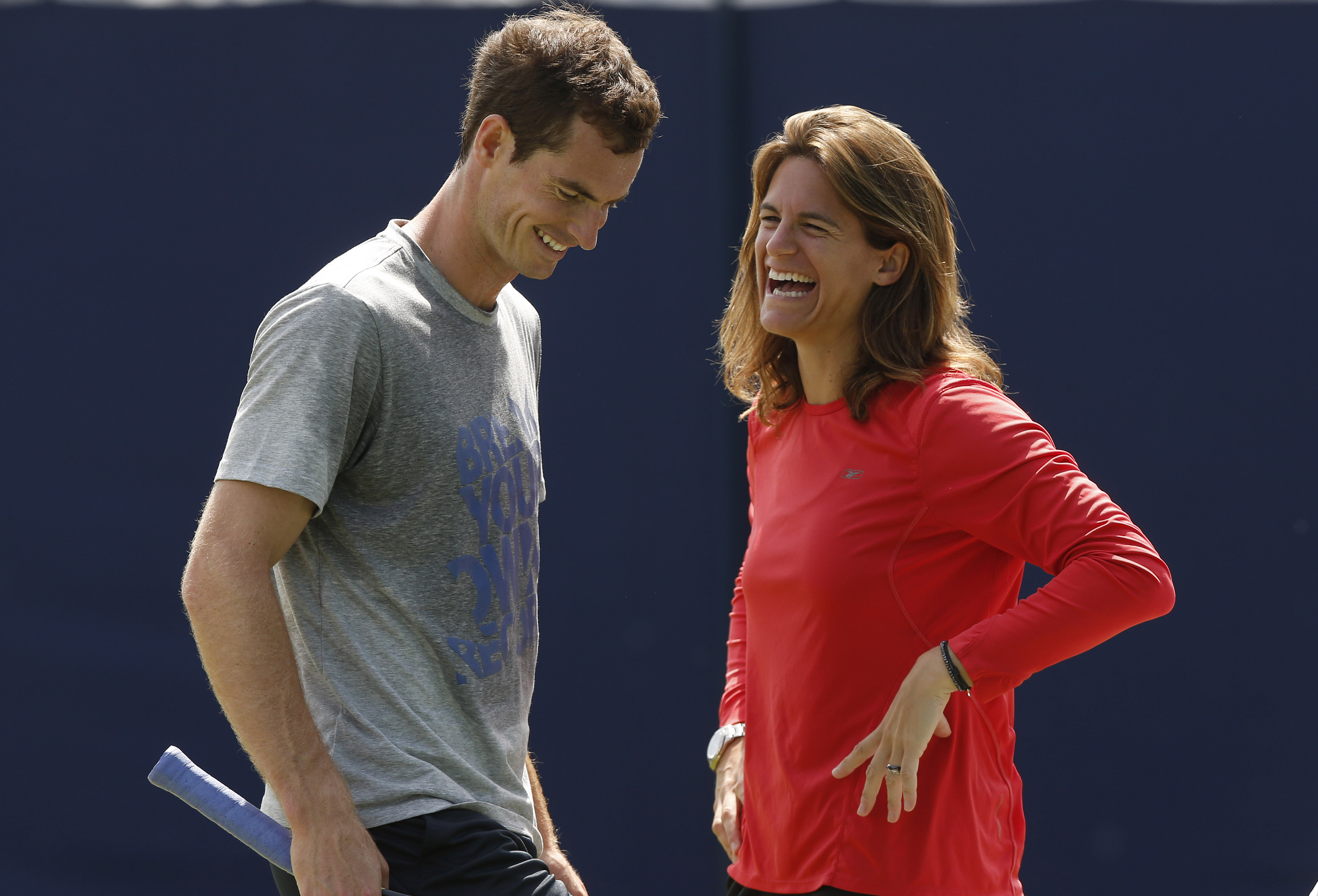 Andy Murray of Britain shares a laugh with his new coach Amelie Mauresmo during a training session before his Queen's Club grass court championships tennis match in London on June 12, 2014. (Sang Tan—AP)