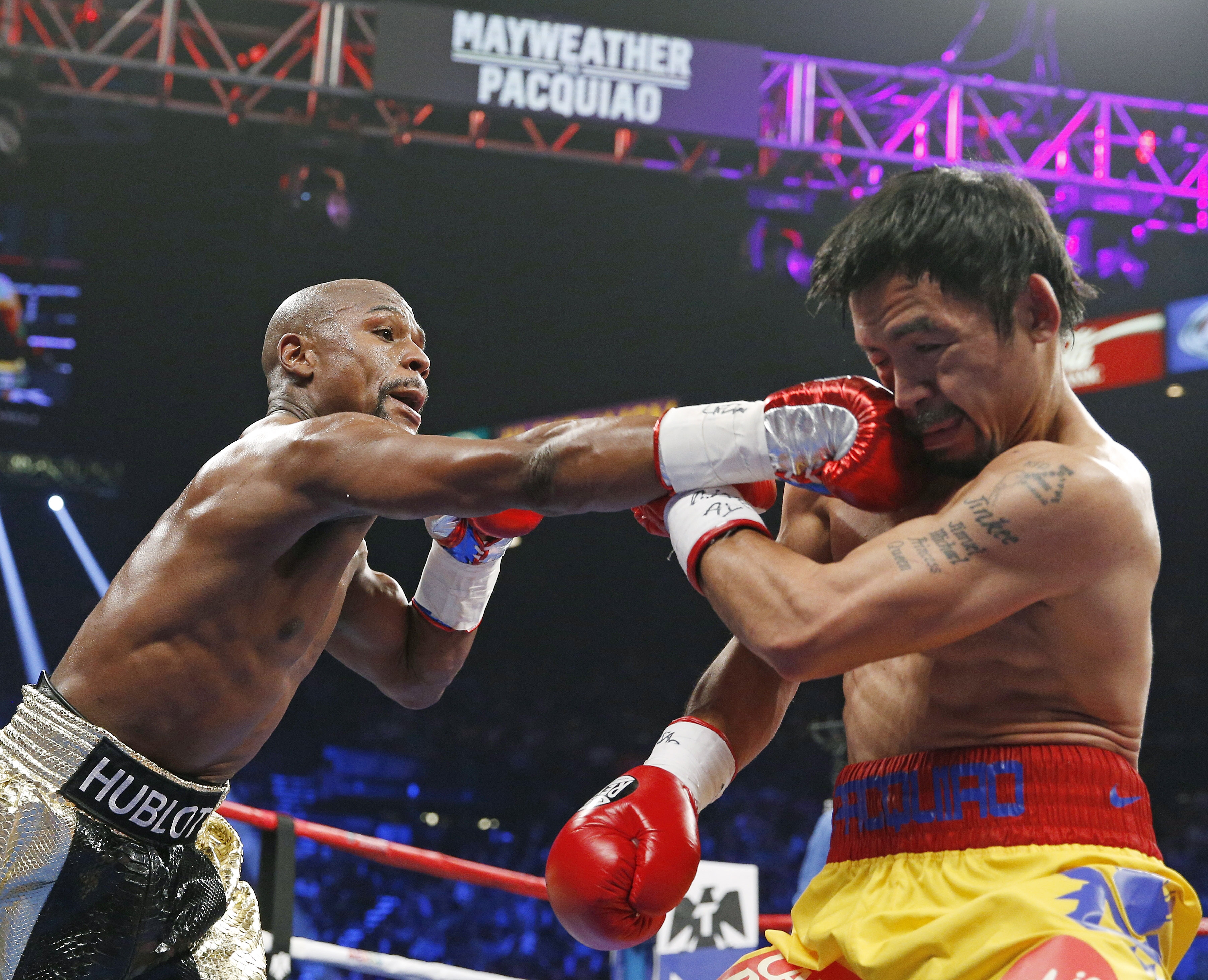 Floyd Mayweather Jr., left, connects with a right jab to the head of Manny Pacquiao in Las Vegas on May 2, 2015 (John Locher—AP)