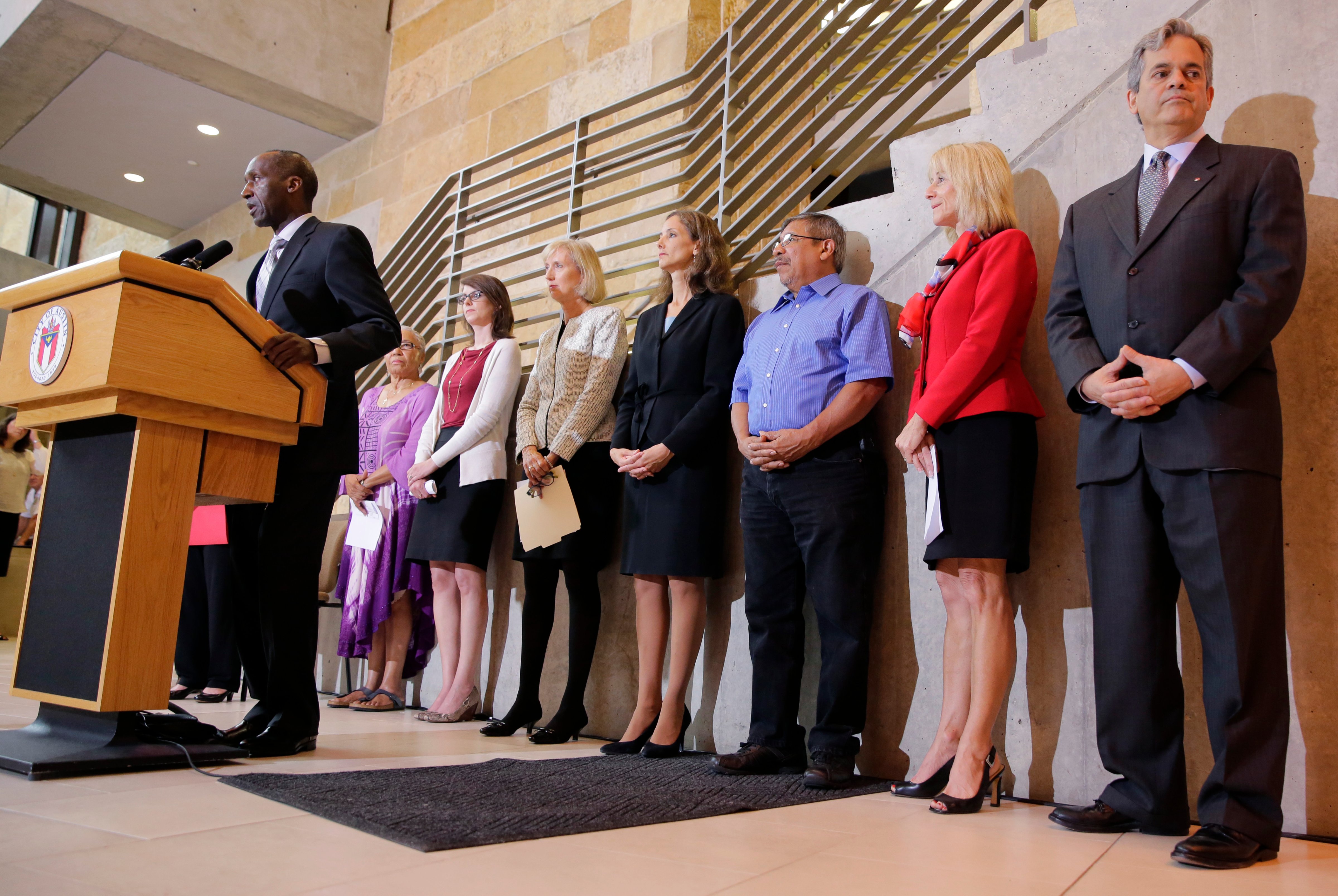 Members of the Austin city council listen to city manager Marc Ott during a news conference at City Hall, on May 13, 2015, in Austin, Texas.