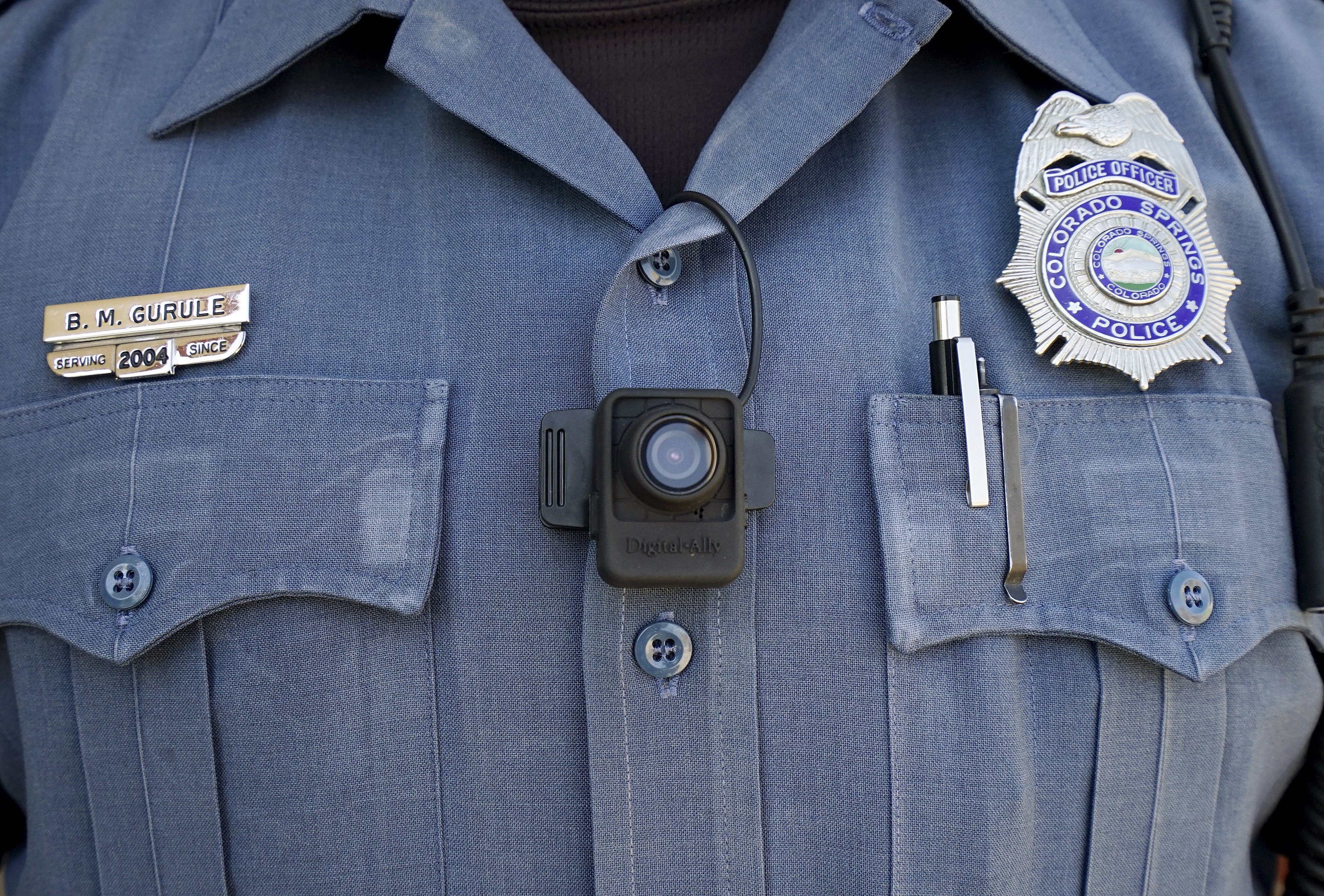 Brian Gurule, a Colorado Springs motor officer poses with a Digital Ally First Vu HD body worn camera worn on his chest in Colorado Springs on April 21, 2015.