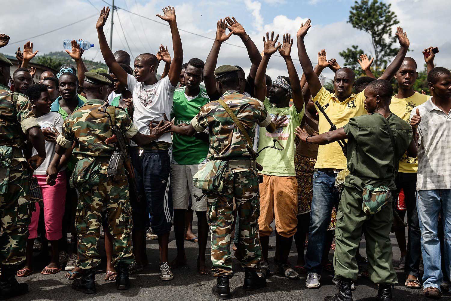 Burundi's army forces hold protestors during a demonstration against incumbent president Pierre Nkurunziza's bid for a 3rd term in Bujumbura, Burundi on May 13, 2015.