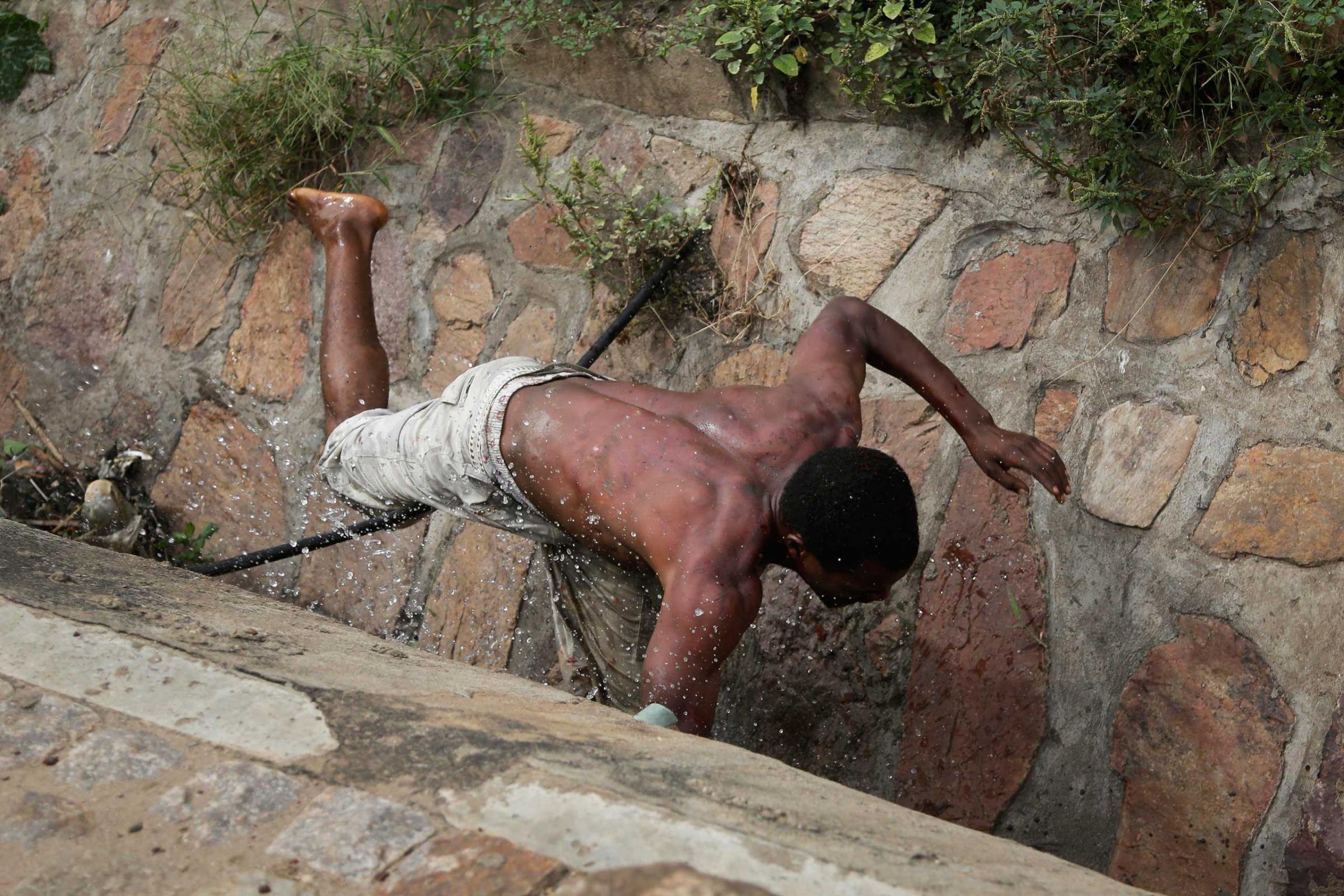 Niyonzima falls in the sewer as he flees from his house under a hail of stones thrown by a mob.