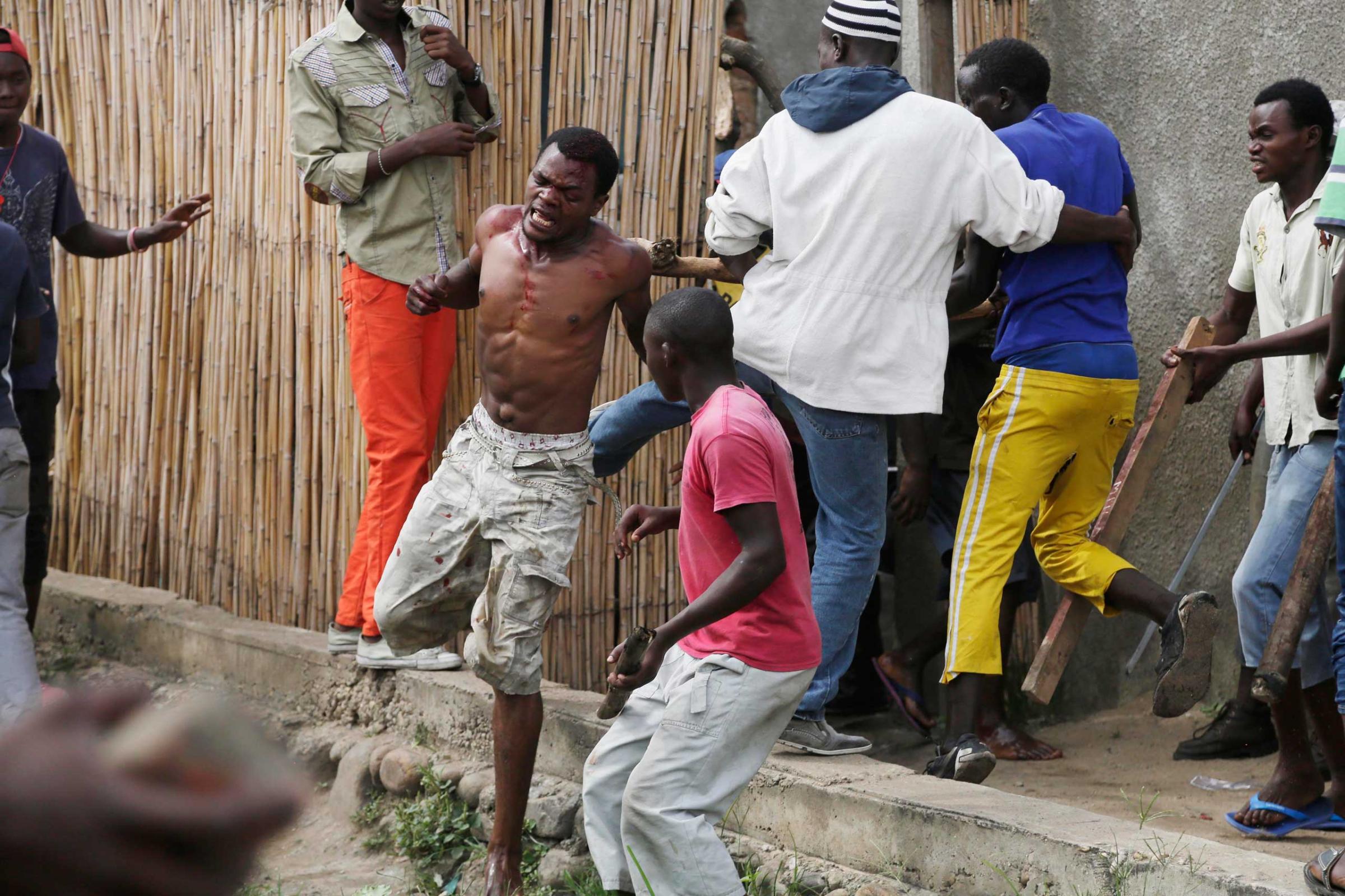 Niyonzima flees from his house while surrounded by a mob.