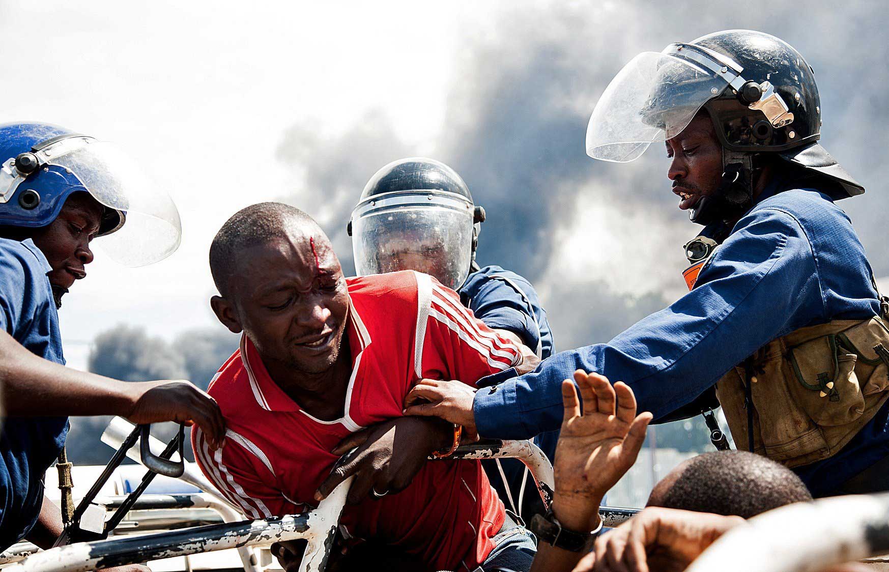 A man is lifted by police during a protest in Bujumbura on May 13, 2015.