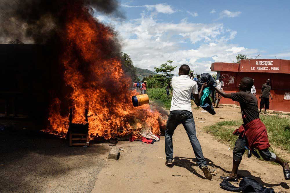 People burn mattresses looted from the local police post neighborhood in Bujumbura, during a protest against incumbent president Pierre Nkurunziza's bid for a 3rd term on May 13, 2015.