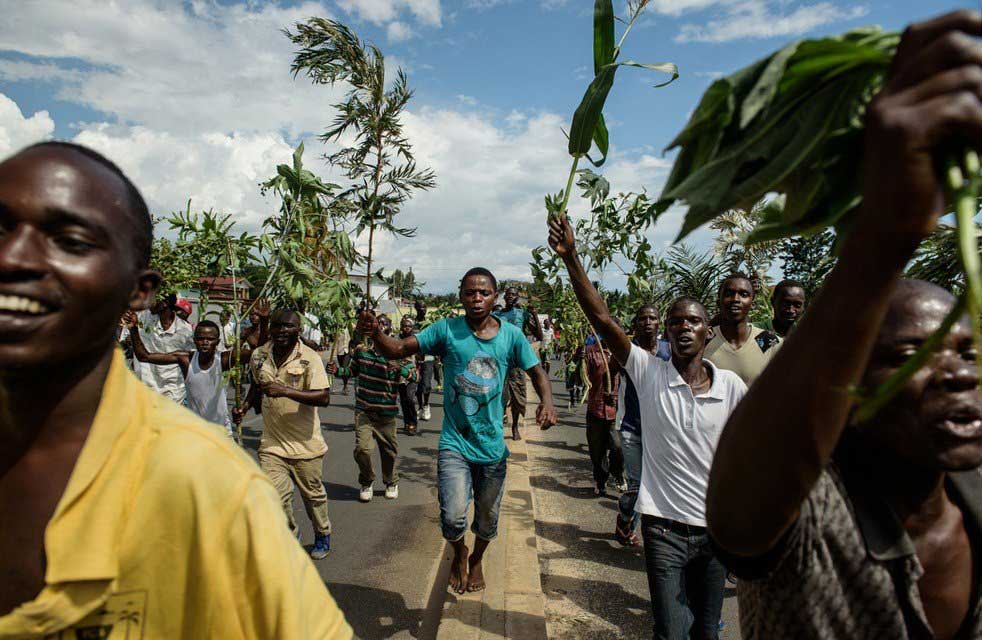 People waving branches celebrate in the streets of Bujumbura following the radio announcement by Major General Godefroid Niyombare that President Pierre Nkurunziza was overthrown on May 13, 2015.