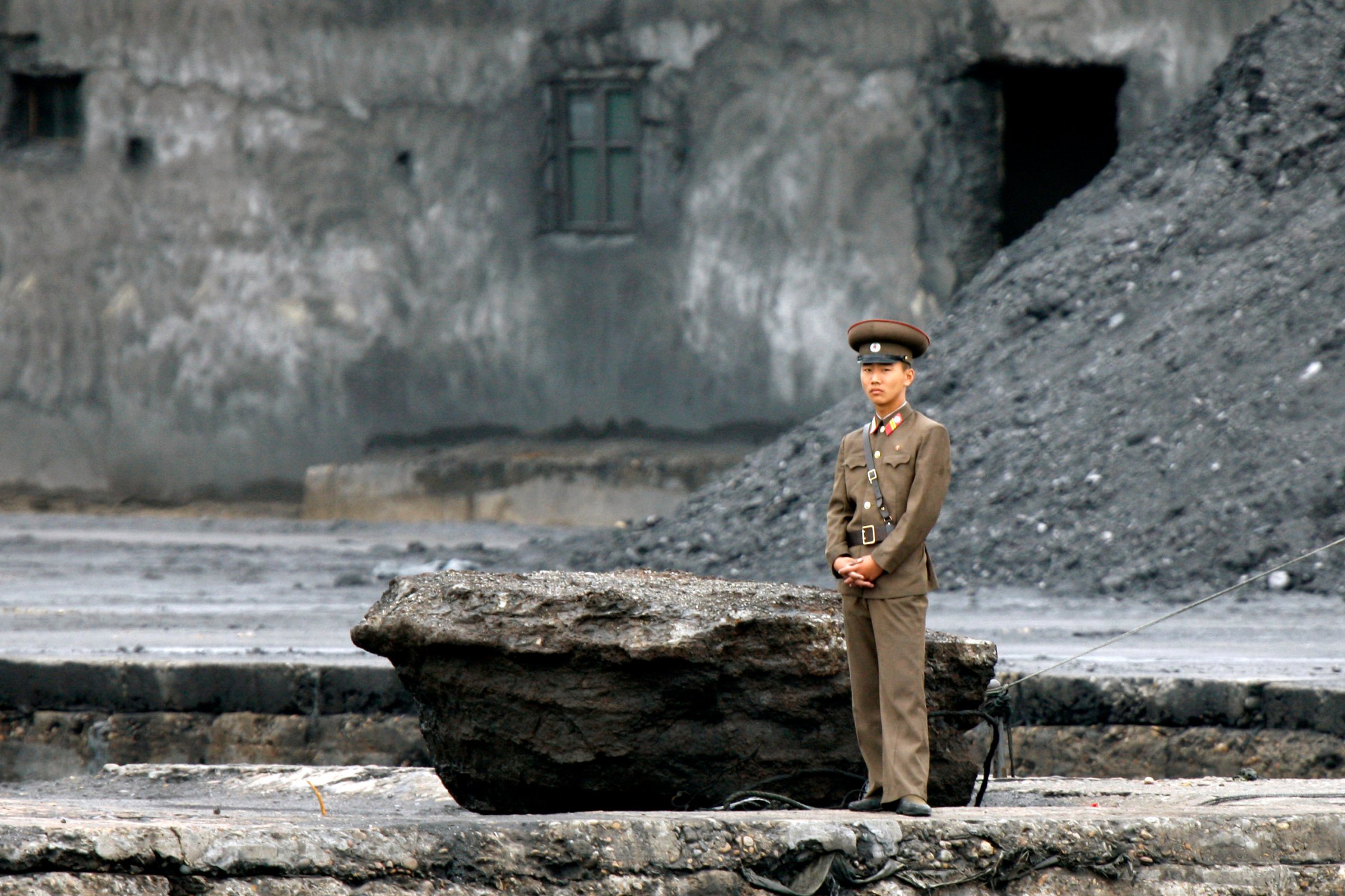 A North Korean soldier stands on the river bank in Sinuiju, North Korea, opposite the Chinese border city of Dandong