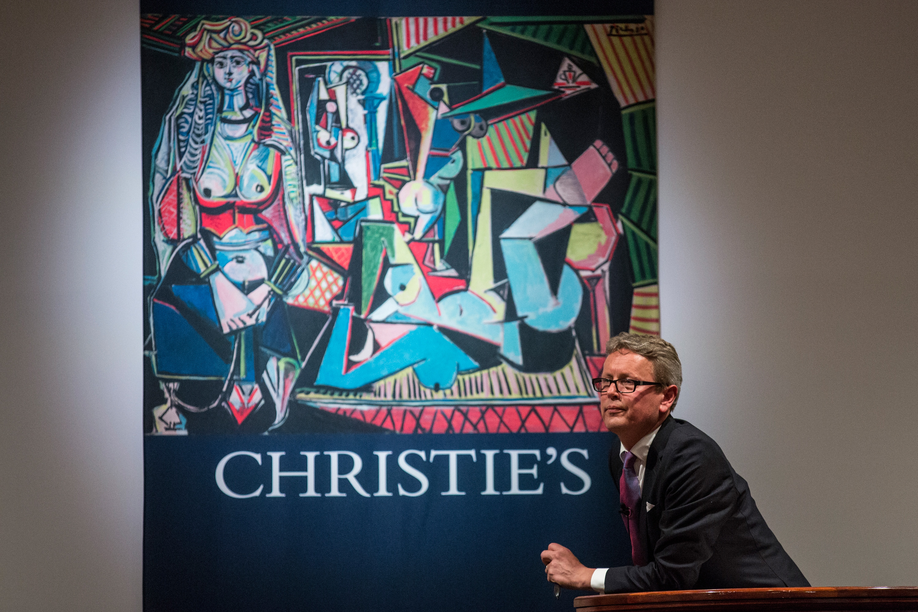 Jussi Pylkkanen, president of Christie's, takes bids at an auction for the art work, "Les femmes d'Alger (Version O)" painted by Pablo Picasso, at Christie's on May 11, 2015 in New York City