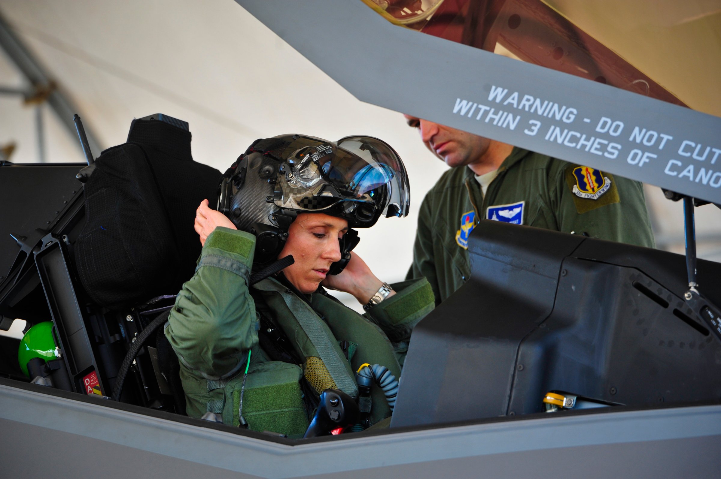 Lt. Col. Christine Mau, 33rd Operations Group deputy commander, puts on her helmet before taking her first flight in the F-35A on Eglin Air Force Base, Fla.