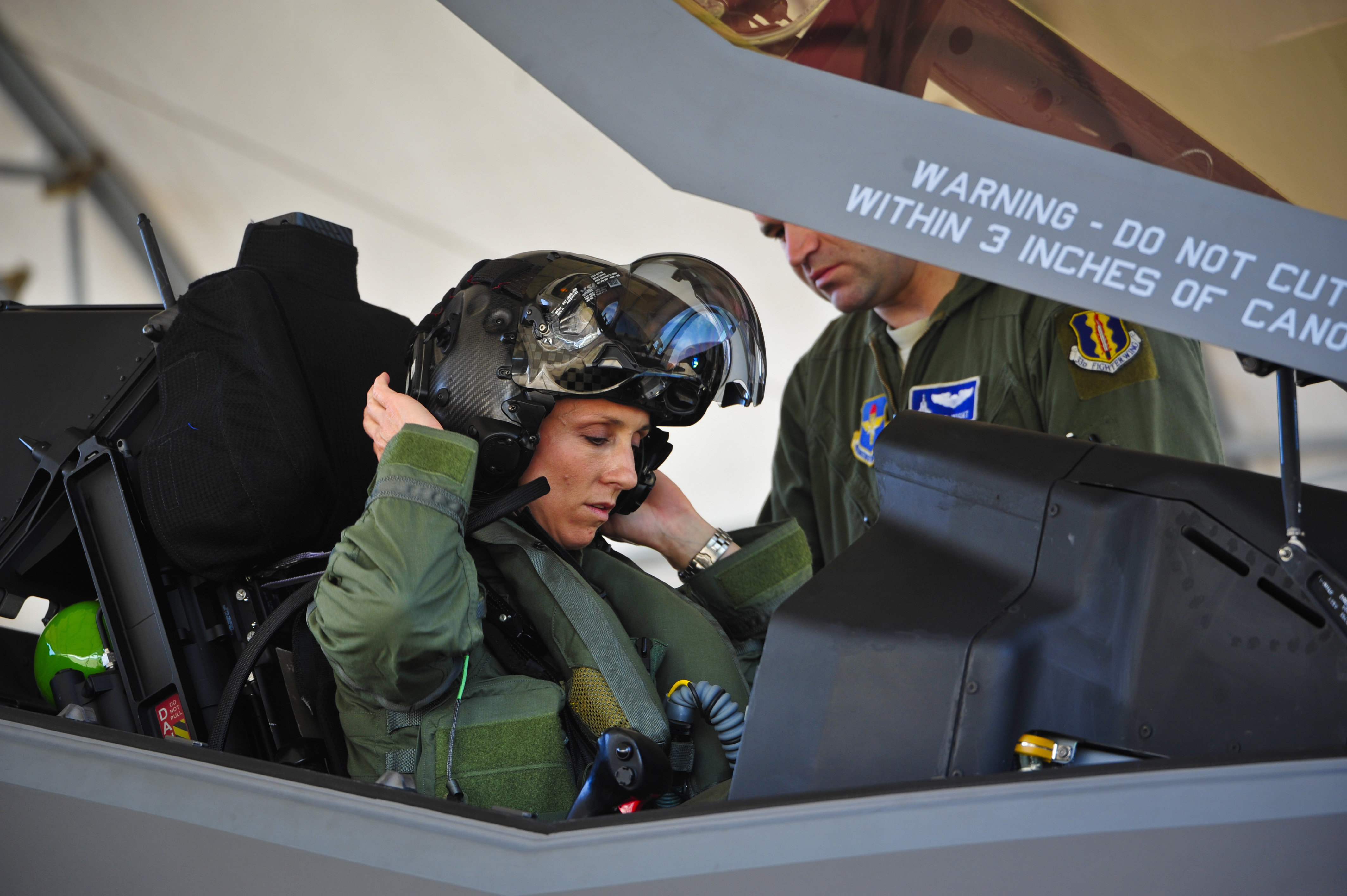 Lt. Col. Christine Mau, 33rd Operations Group deputy commander, puts on her helmet before taking her first flight in the F-35A on Eglin Air Force Base, Fla., on May 5, 2015. (Staff Sgt. Marleah Robertson—33rd Fighter Wing/Public Affairs)
