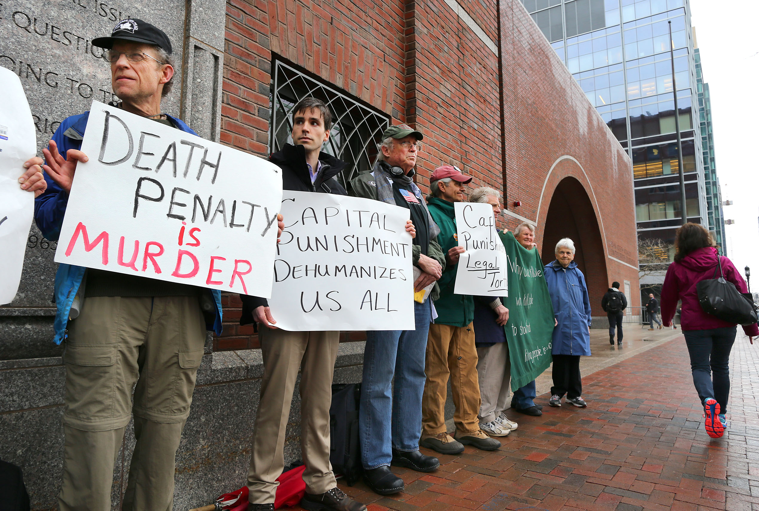 Demonstrators against the death penalty stand outside the Moakley Federal Court during first day of the penalty phase for Boston Marathon bomber Dzhokhar Tsarnaev on April 21, 2015 in Boston.