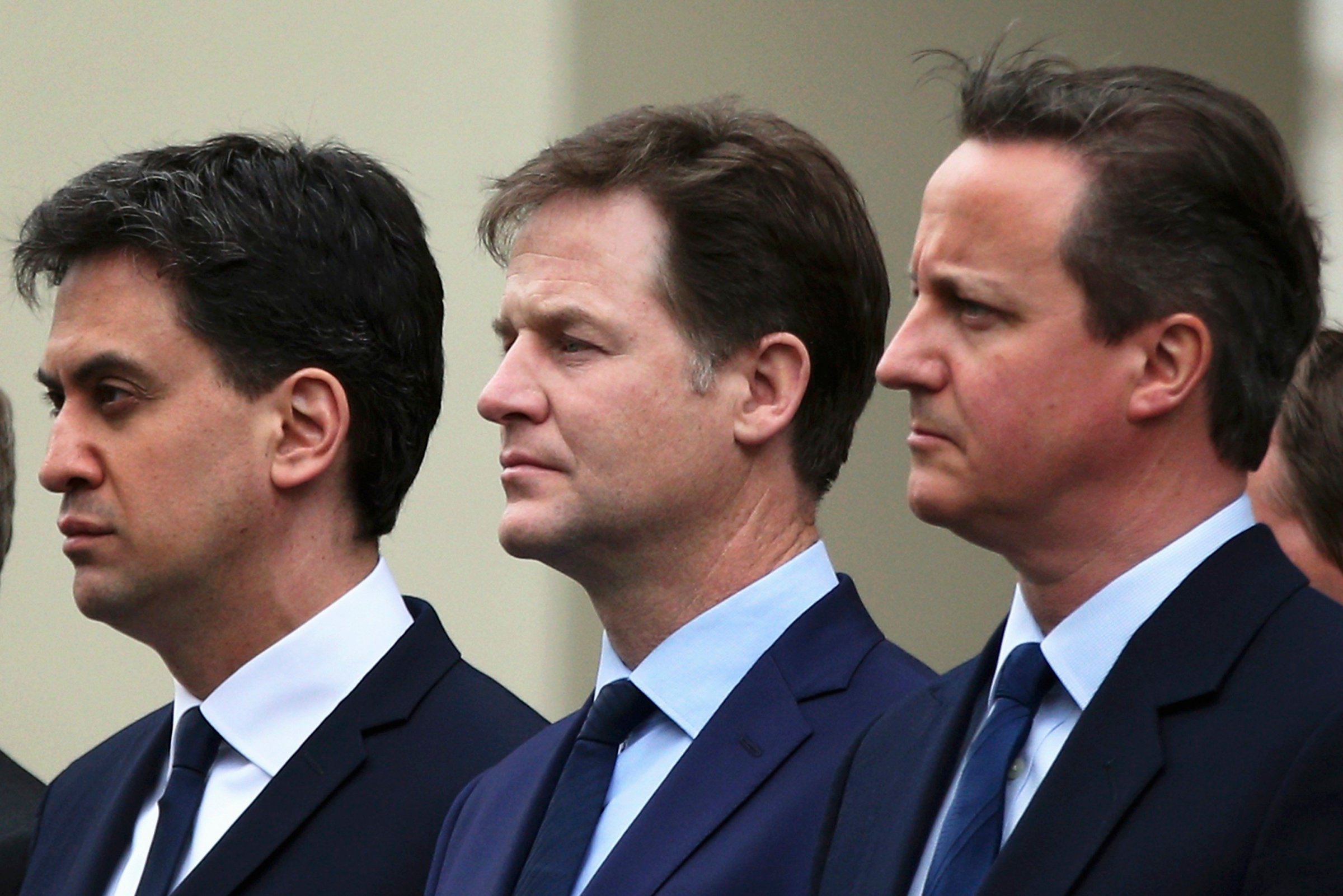 Britain's Prime Minister David Cameron (R) stands with former former Liberal Democrat leader Nick Clegg (C) and former Labour Party leader Ed Miliband, as they line up to pay tribute at the Cenotaph during a Victory in Europe (VE) day ceremony in central London on May 8, 2015.