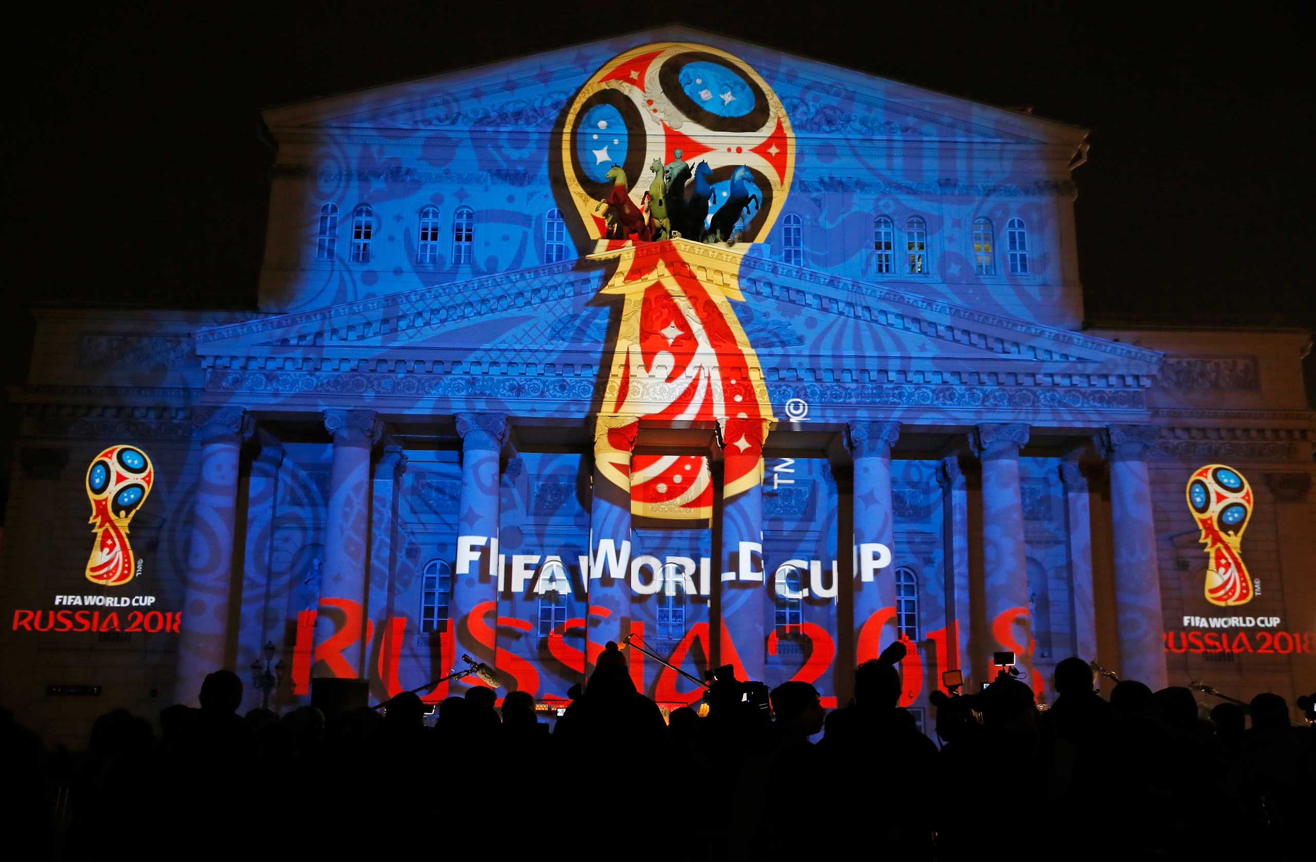 Journalists look at a light installation showing the official logotype of the 2018 FIFA World Cup during its unveiling ceremony at the Bolshoi Theater building in Moscow, October 28, 2014. (Maxim Shemetov—Reuters)