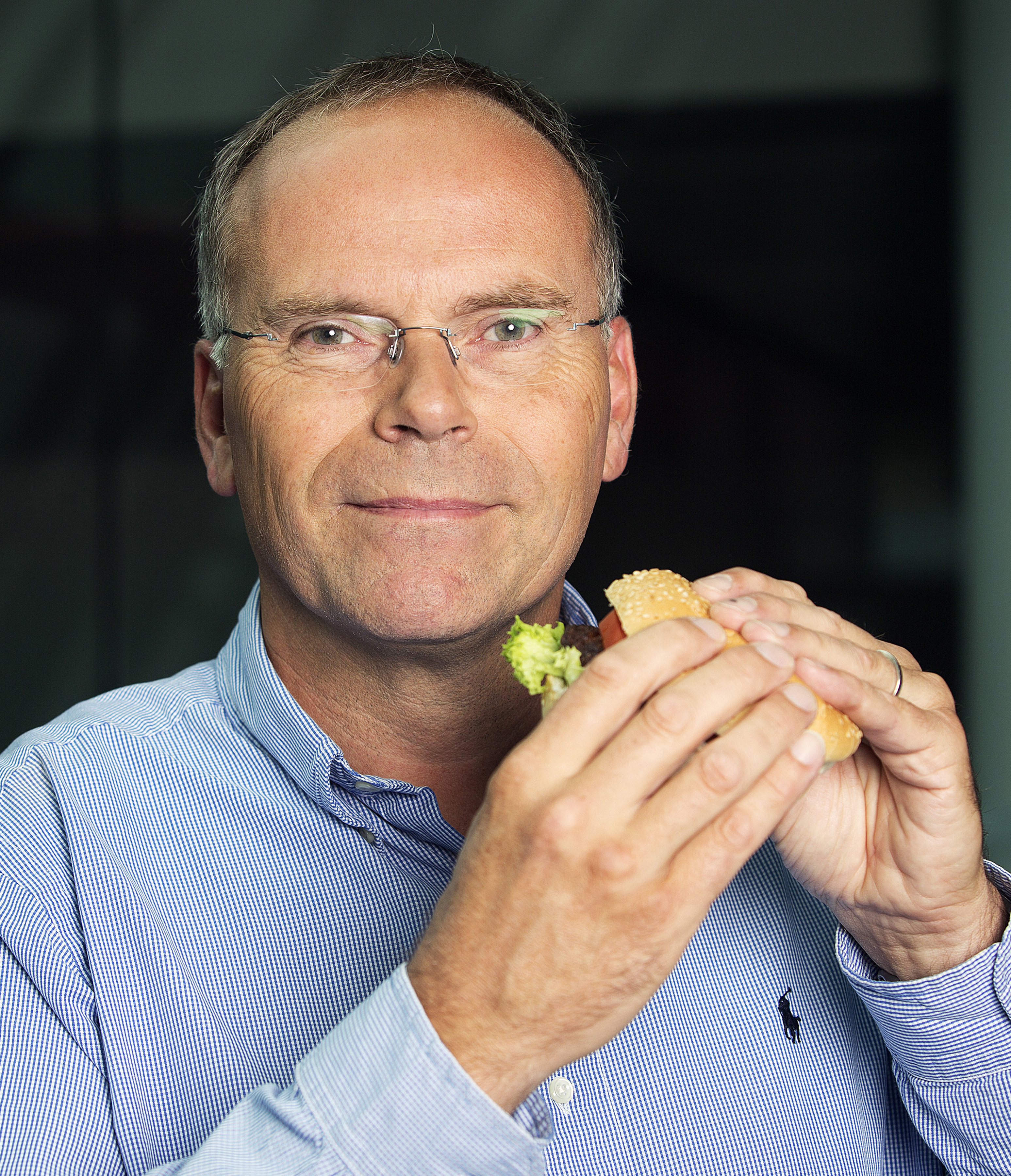 Mark Post, a Dutch scientist, poses for a photograph while holding the world's first beef burger created from stem cells harvested from a living cow following a Bloomberg Television interview in London, U.K., on Tuesday, Aug. 6, 2013. (Simon Dawson—Bloomberg /Getty Images)
