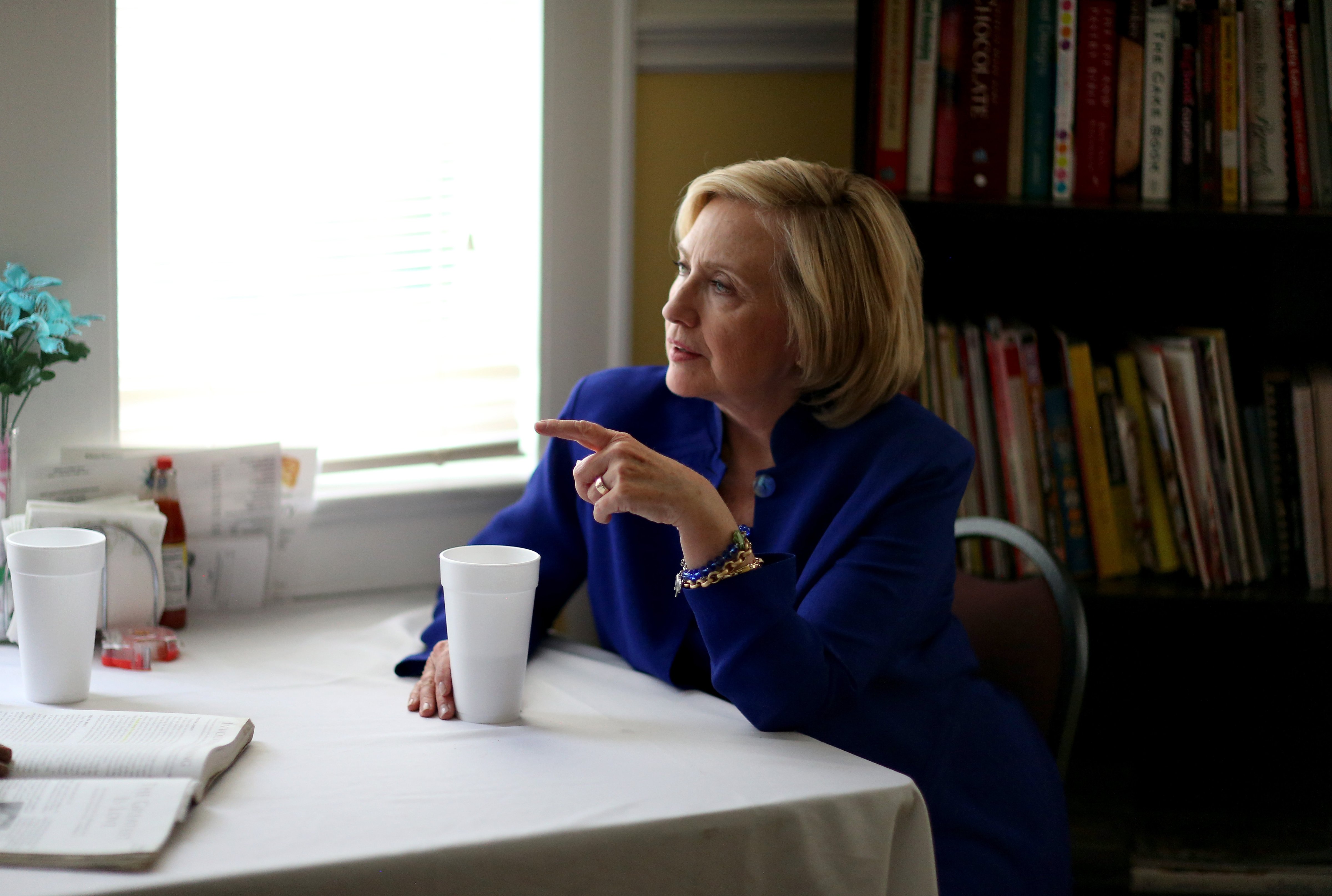 Democratic Presidential candidate Hillary Clinton sits with a customer as she visits the Main Street Bakery on May 27, 2015 in Columbia, South Carolina. (Joe Raedle—Getty Images)