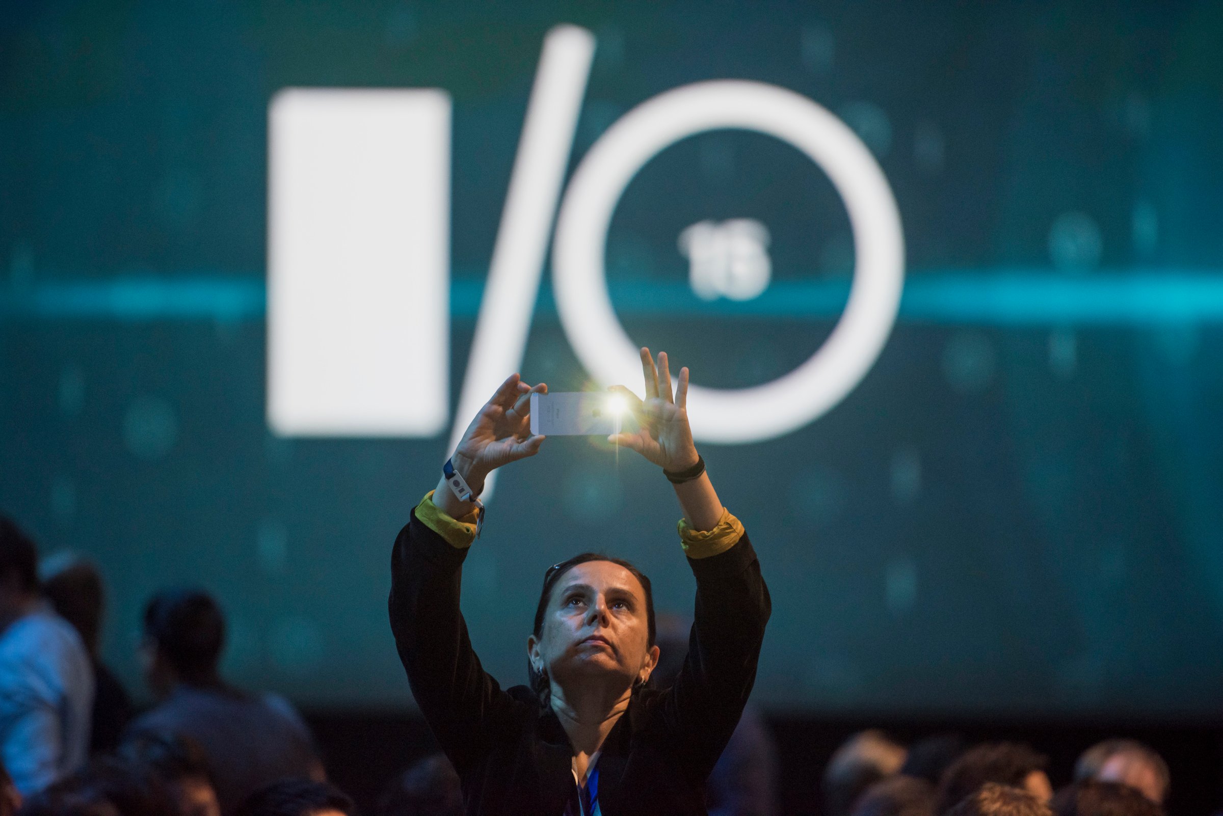 An attendee takes a photograph prior to the Google I/O Annual Developers Conference in San Francisco, California, U.S., on Thursday, May 28, 2014. Google Inc. executives are taking the stage this week to talk about a plethora of new technologies, including automobiles, home automation, digital TV, Web-connected devices and a new version of Android. Photographer: David Paul Morris/Bloomberg