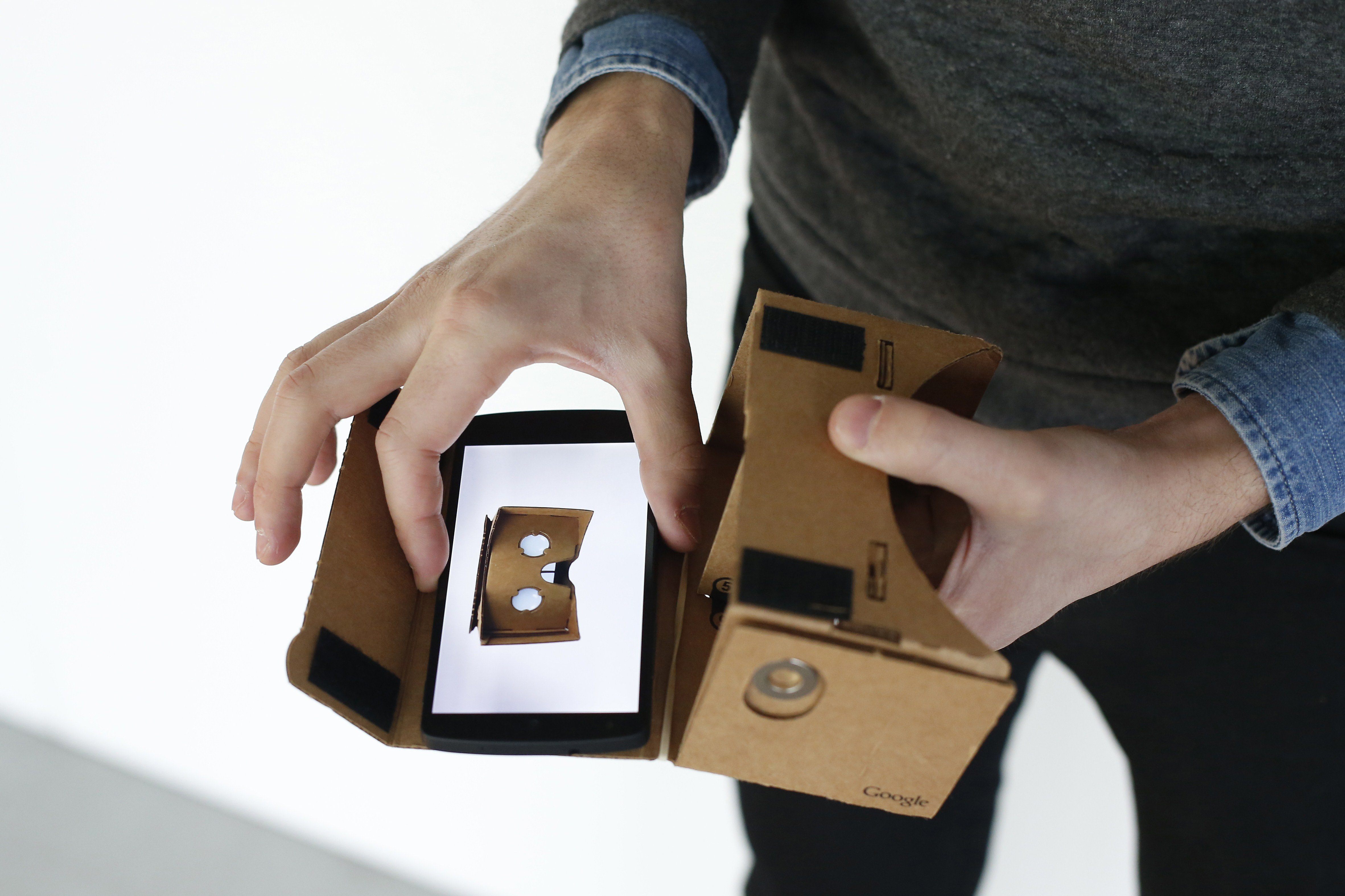 A Google employee presents a Google Cardboard virtual reality headset for android smartphones during a Google promotion event at the City of Fashion and Design (Cite de la mode et du design) in Paris on November 4, 2014. (Thomas Samson&mdash;AFP/Getty Images)