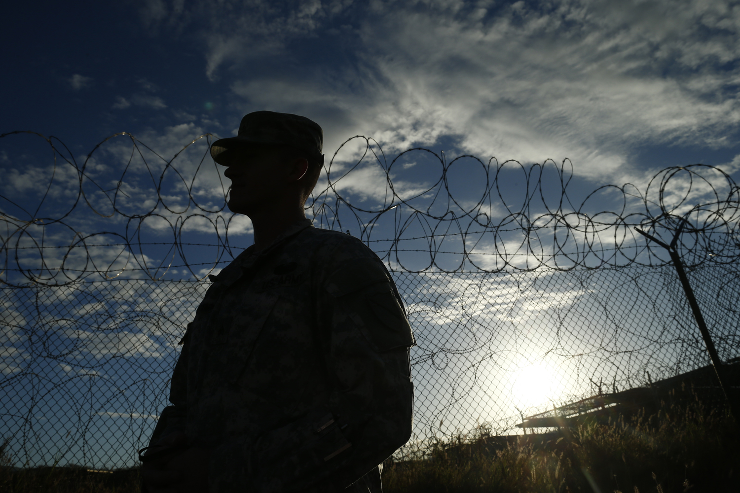 A soldier stands at the now closed Camp X-Ray, which was used as the first detention facility for al-Qaeda and Taliban militants who were captured after the Sept. 11, 2001, attacks, at Guant&aacute;namo Bay Naval Base, Cuba, on Nov. 21, 2013 (Charles Dharapak—AP)