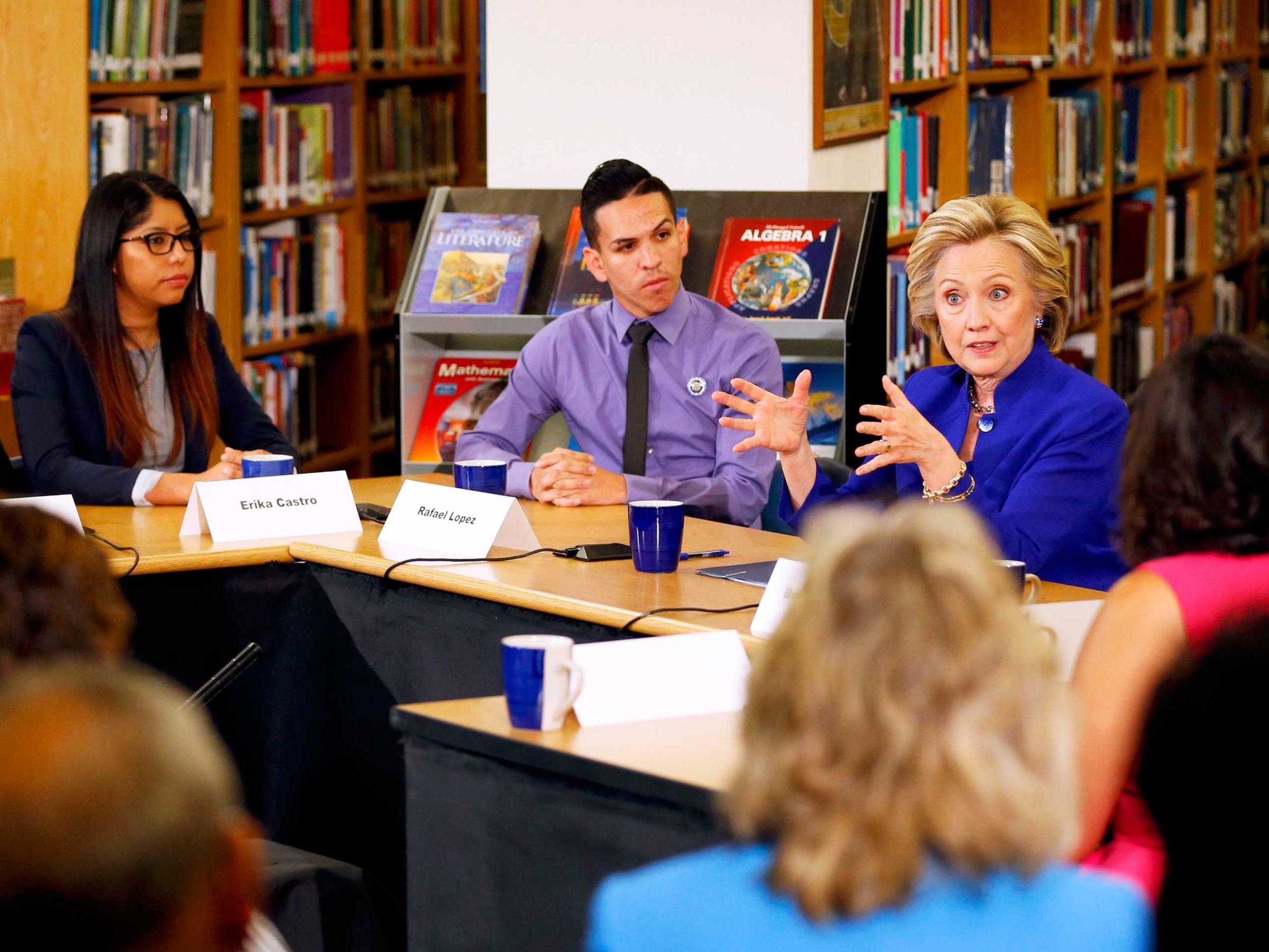 Former U.S. Secretary of State Hillary Clinton (R) takes part in a roundtable of young Nevadans discussing immigration as she campaigns for the 2016 Democratic presidential nomination at Rancho High School in Las Vegas, on May 5, 2015.