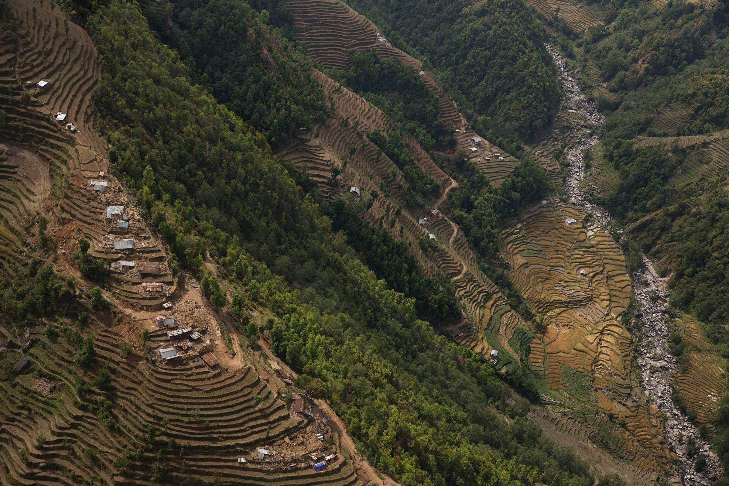Nepal earthquake. Town of Sankhu. Mush of town was destroyed. People digging out their possessions. Aerial images of Nuwakot district, hit by the earthquake and not able to be reached by aid and rescue teams. Farming villages built atop steep hillsides with cascading, terraced fields.by James Nachtwey