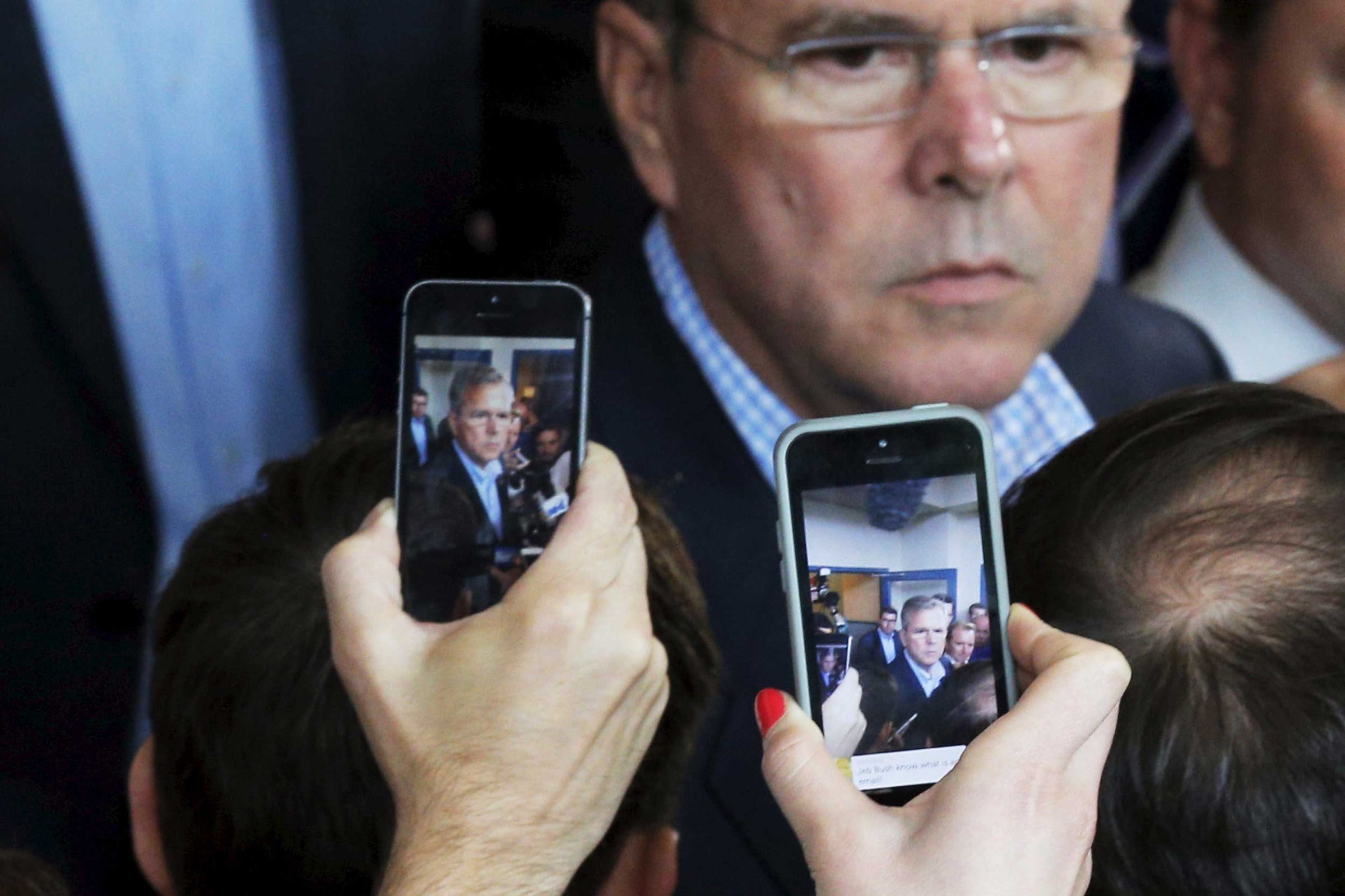 Reporters use their mobile phones to record potential 2016 Republican presidential candidate Jeb Bush as he answers questions after a business roundtable in Portsmouth, N.H. on May 20, 2015.