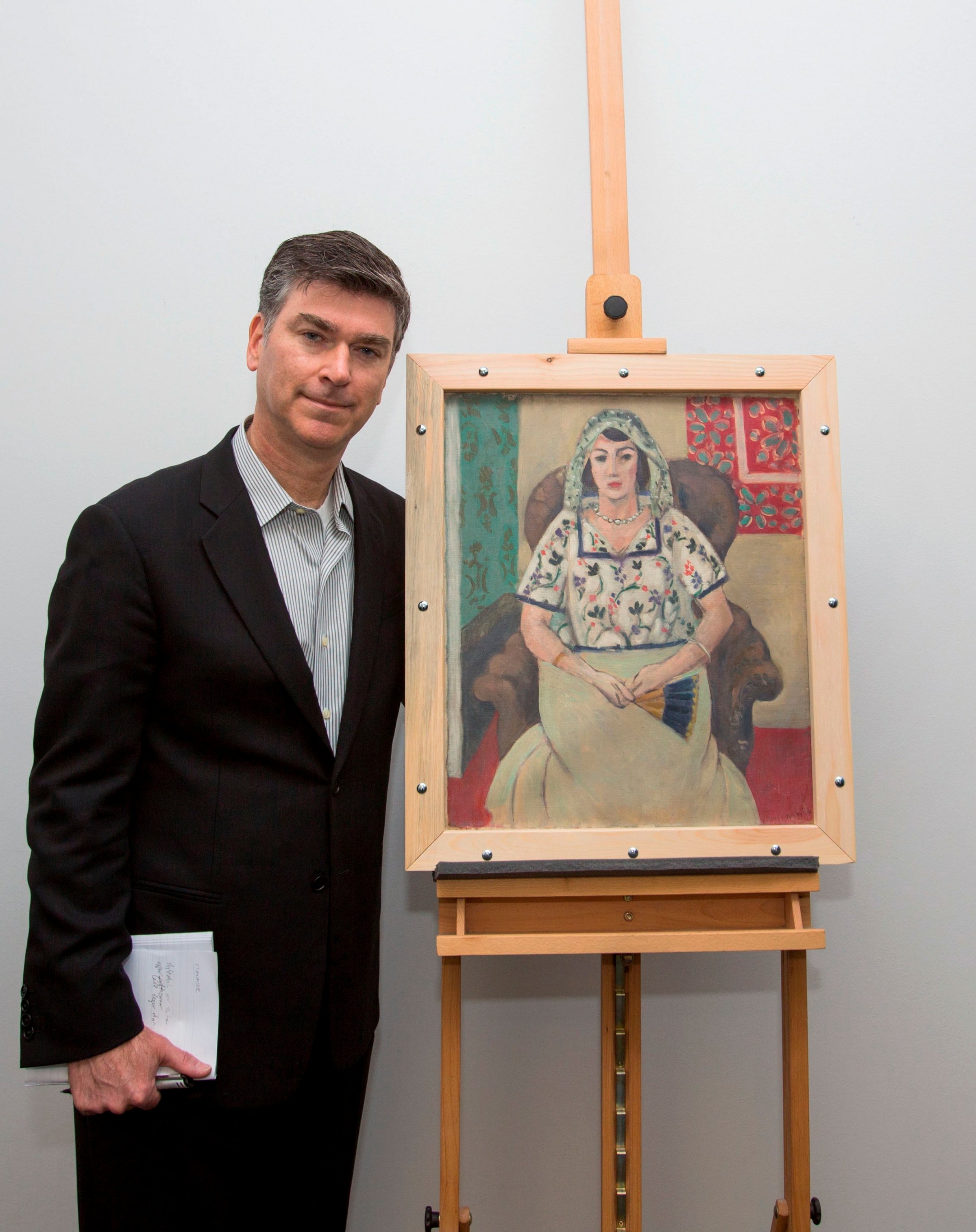 A handout picture provided by Wolf Heider-Sawall Art Recovery Group shows the representative of the Rosenberg family, Christopher Marinello, with the painting 'Seated Woman' by Henri Matisse on behalf of the family in Munich