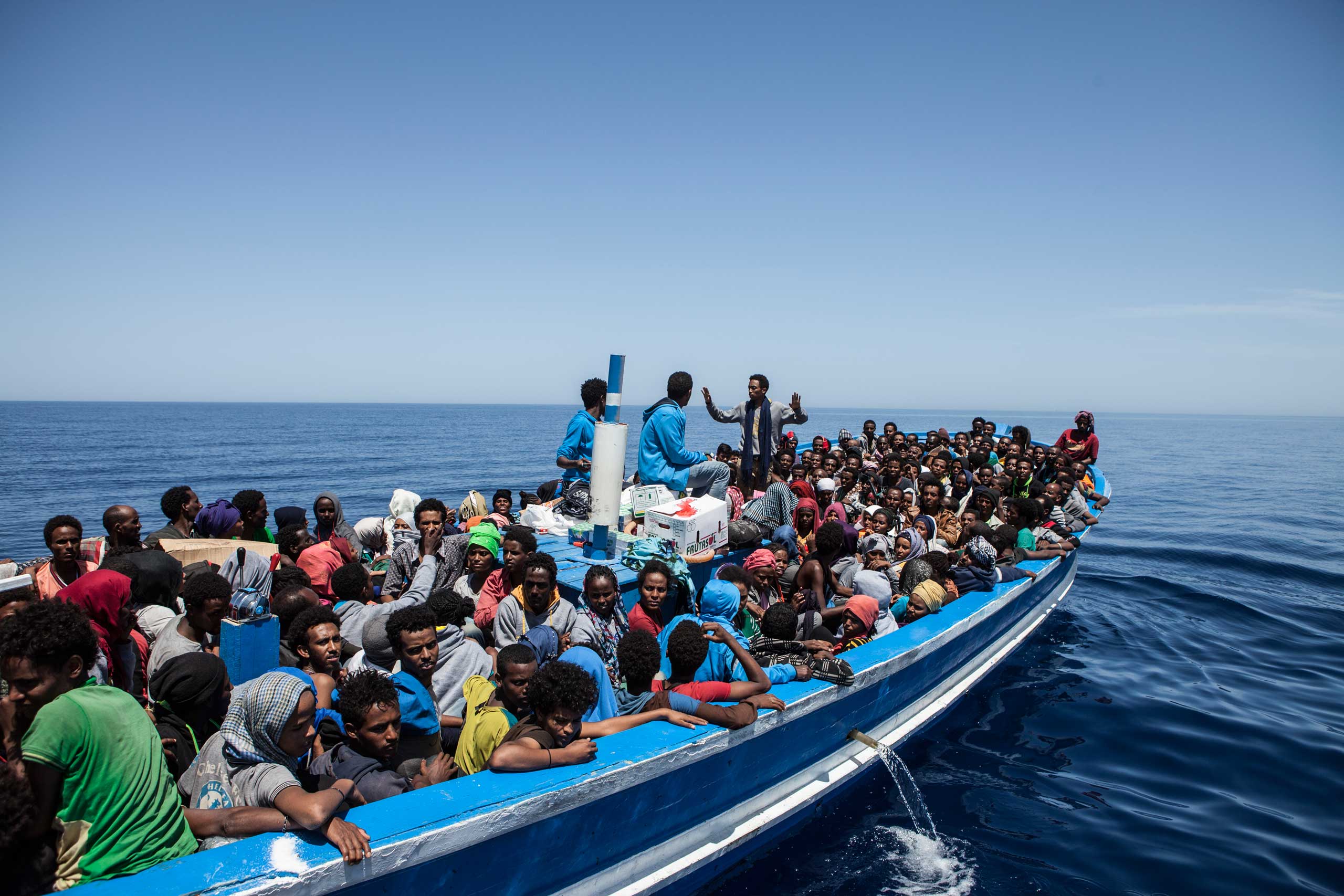 Migrants on a packed wooden boat wait to be rescued off the coast of Malta on May 3, 2015. (Jason Florio—MOAS)