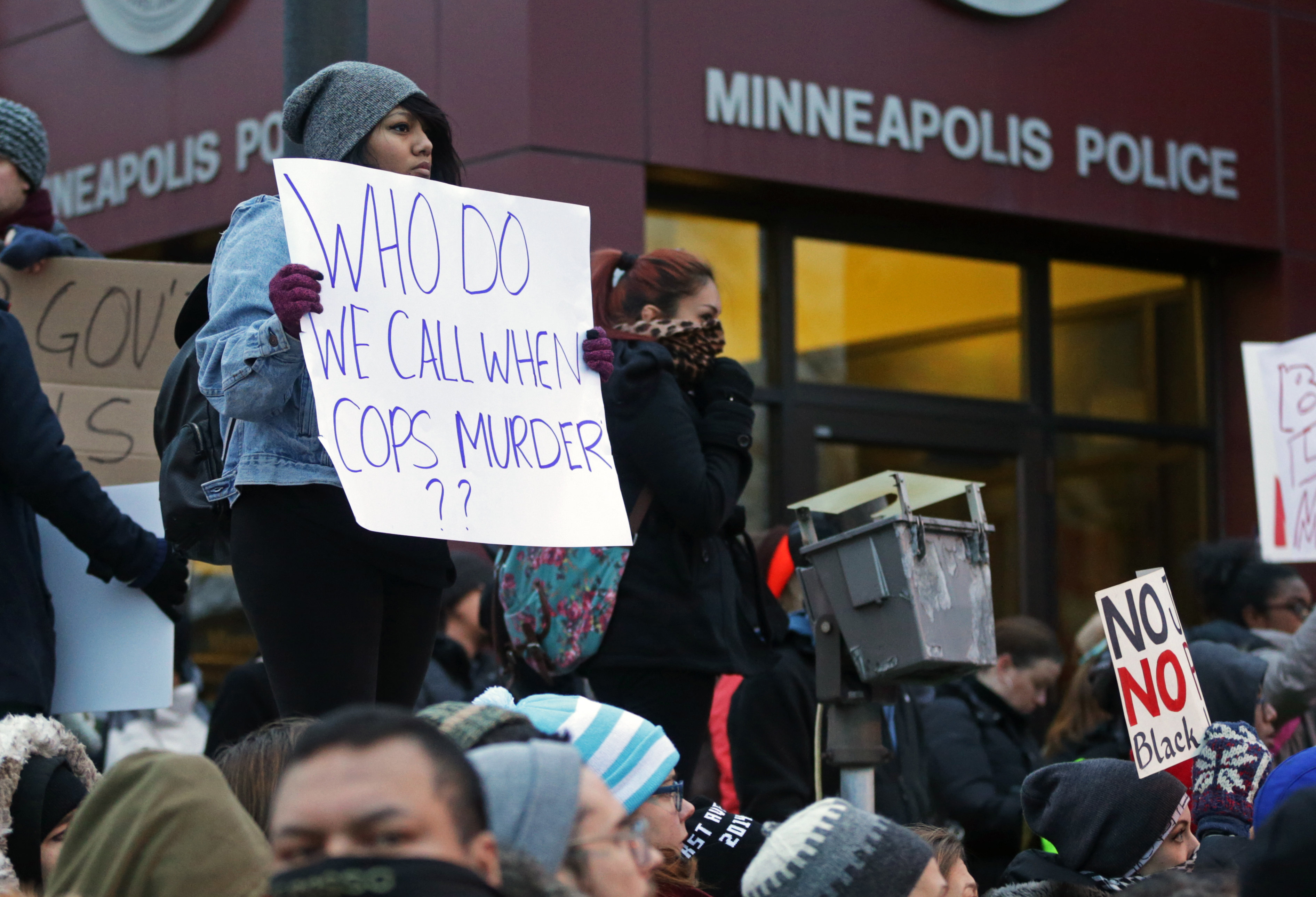Demonstrators rally outside the Minneapolis Police Department's Third Precinct to protest police brutality, on Nov. 25, 2014, in Minneapolis. (Jim Mone—AP)