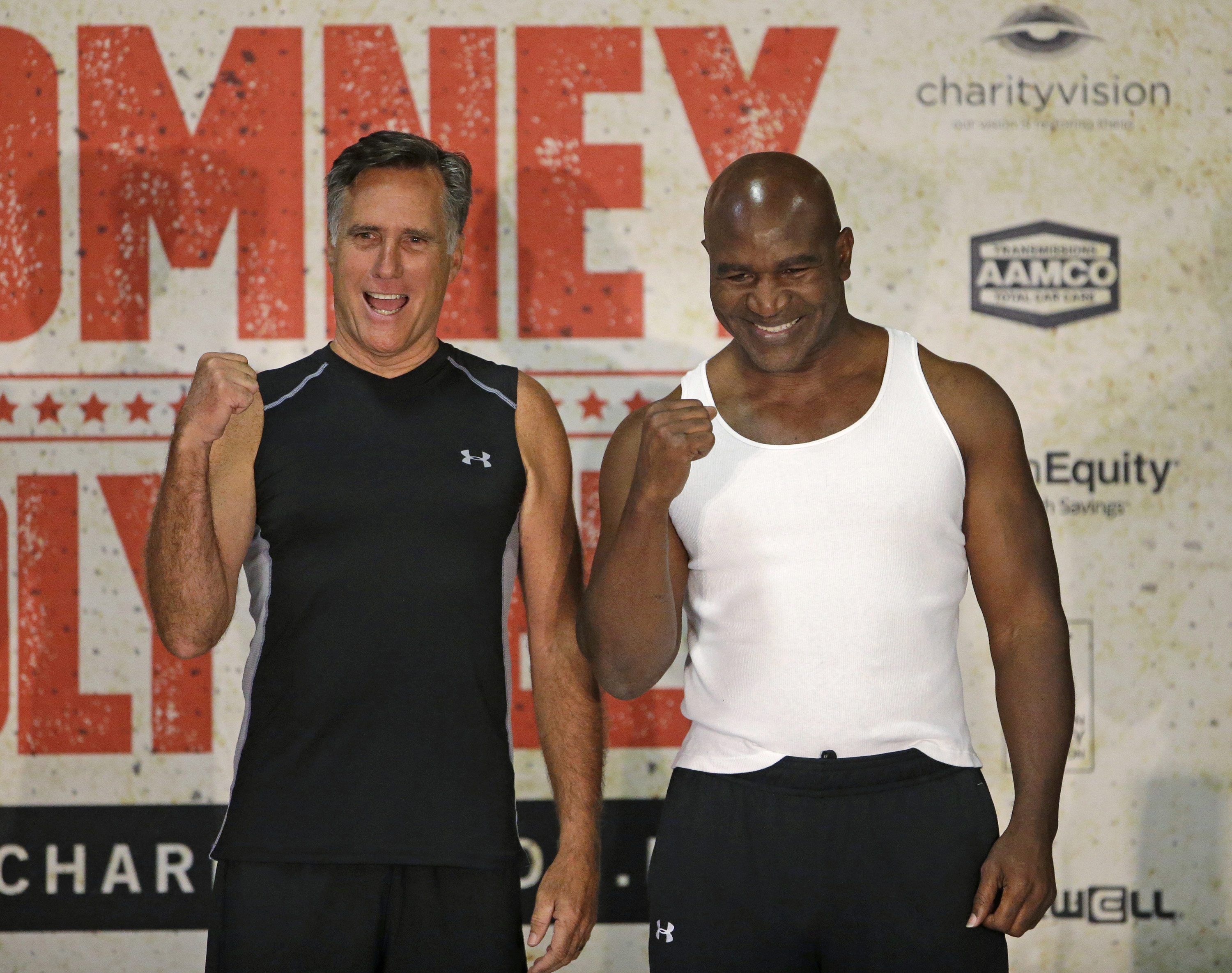 Former Republican presidential candidate Mitt Romney, left, and five-time heavyweight boxing champion Evander Holyfield pose for a photo after an official weigh-in on May 14, 2015, in Holladay, Utah.