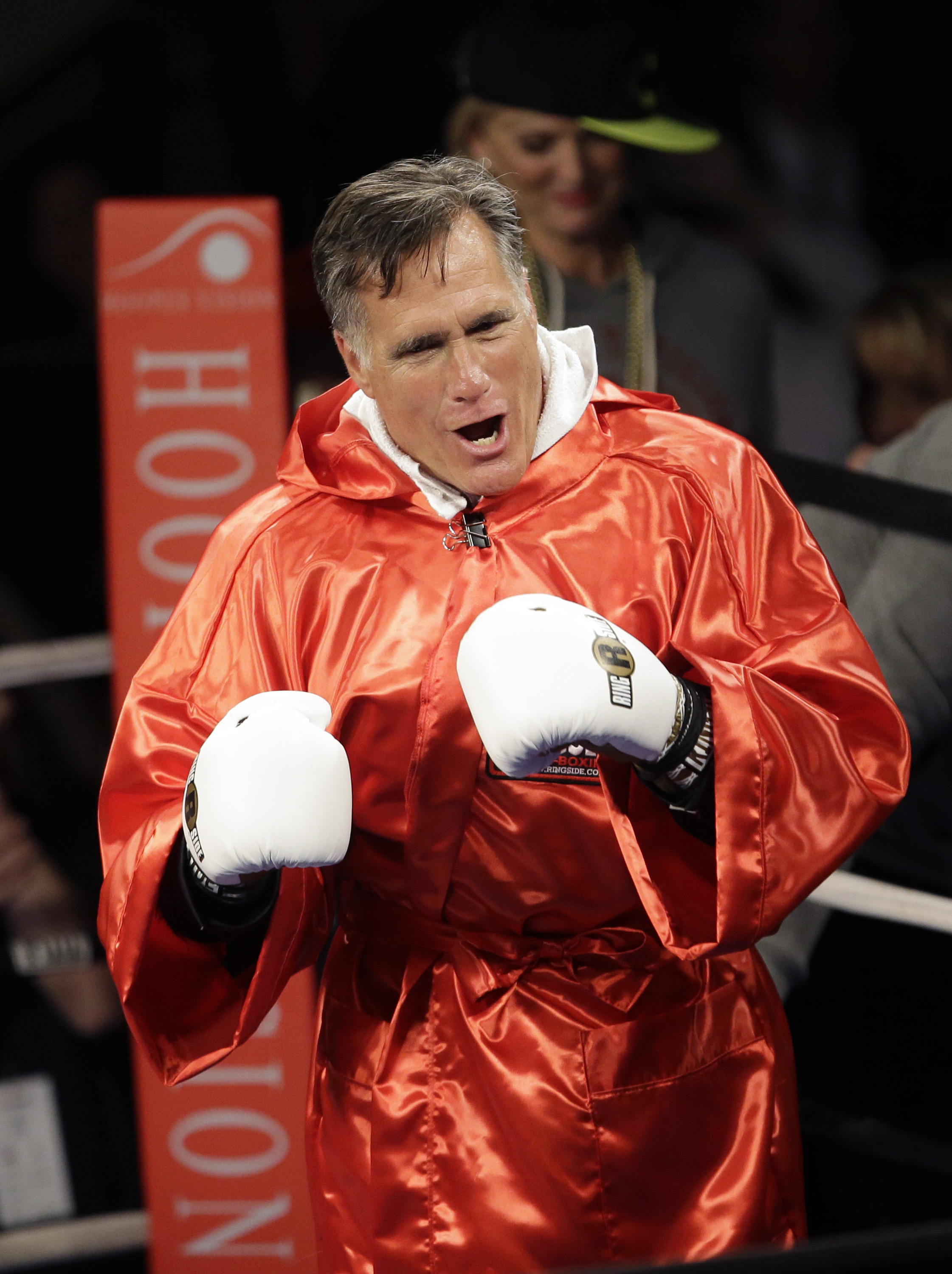 Former Republican presidential candidate Mitt Romney walks in to the ring before sparring with five-time heavyweight boxing champion Evander Holyfield at a charity fight night event on May 15, 2015, in Salt Lake City.