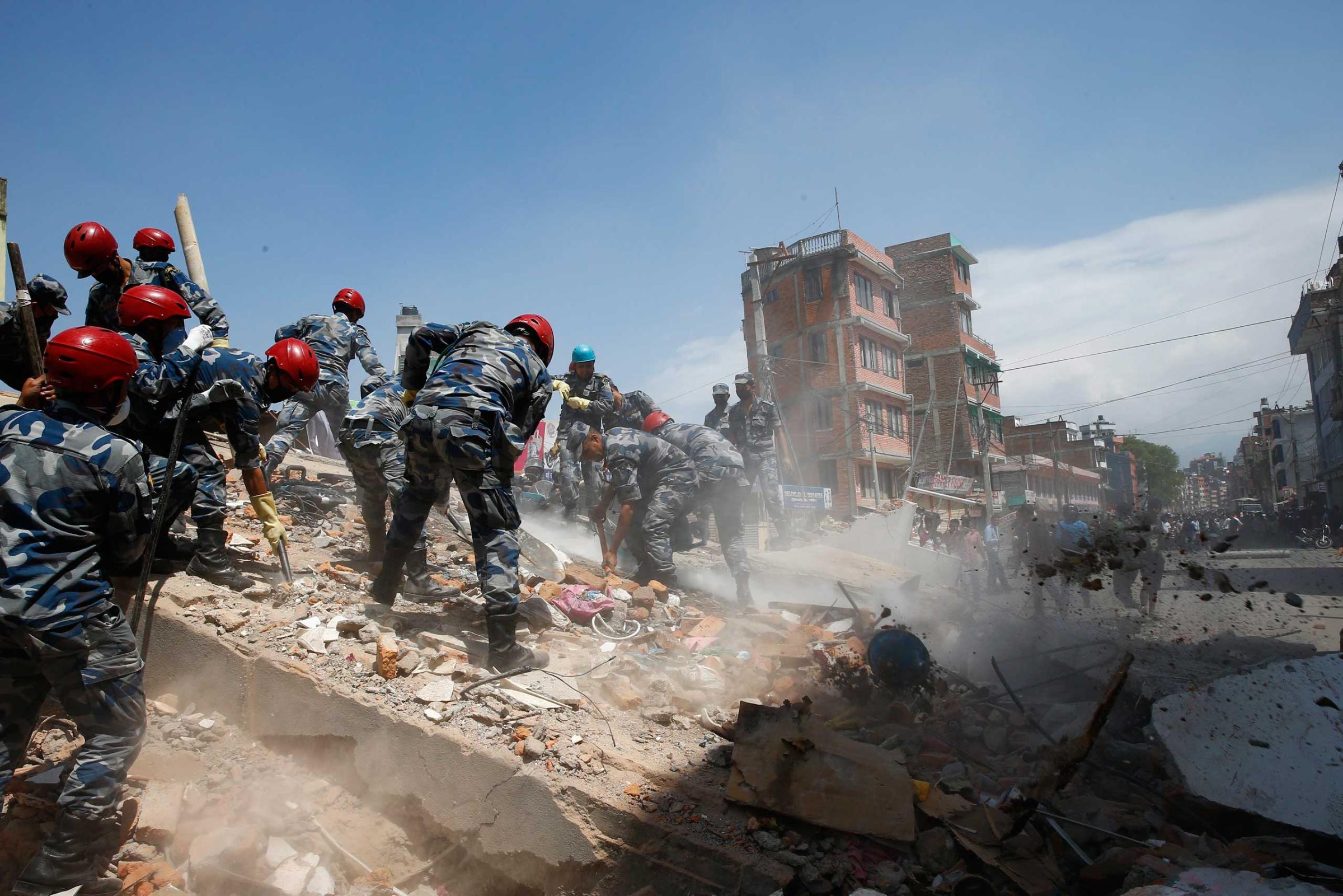Nepalese armed police force search for victims after a house collapsed in strong earthquake hits Kathmandu on May 12 2015.