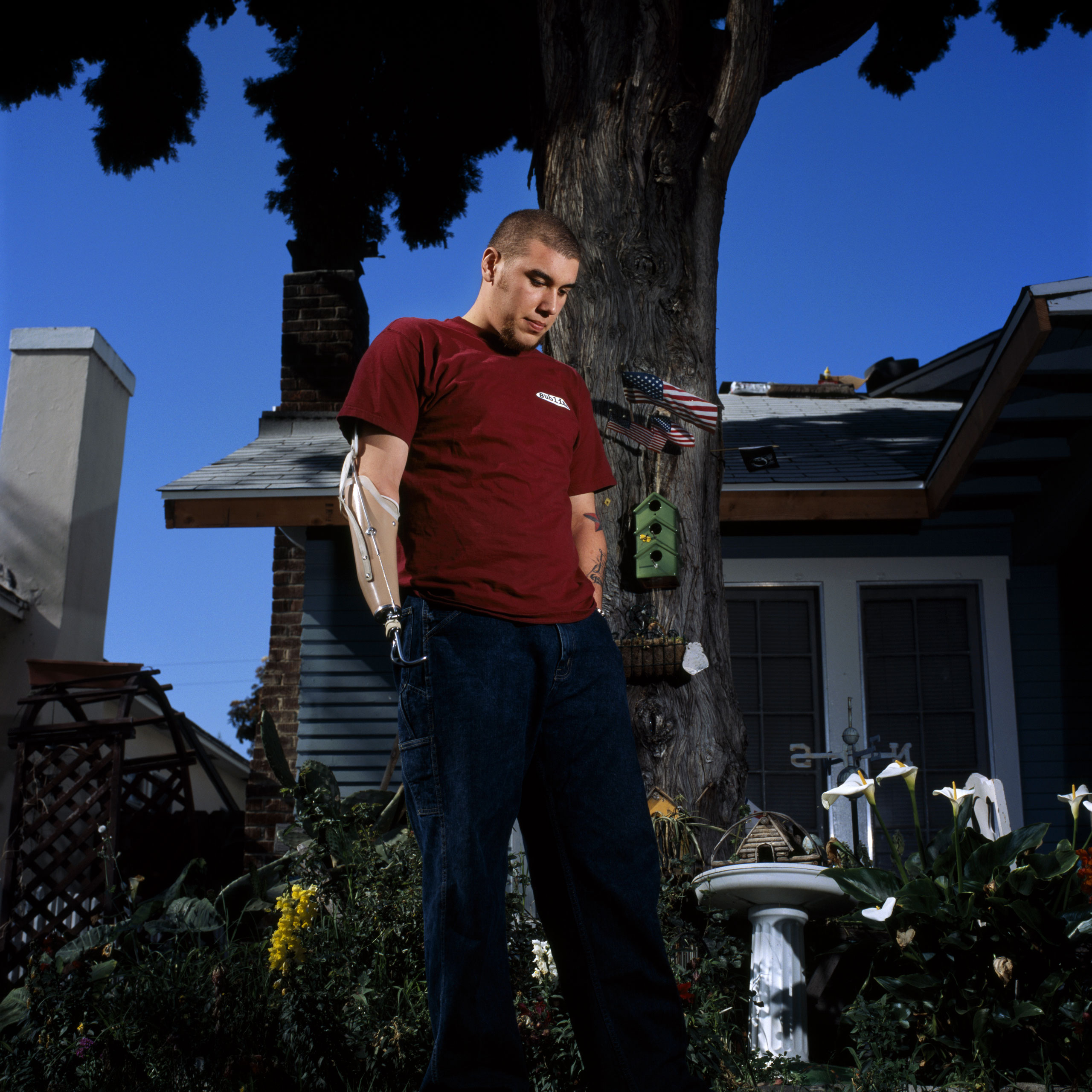 Spc. Robert Acosta, 20, photographed at his home in Santa Ana, Calif., April 13, 2004. Acosta is an ammunition specialist with the 1st Battalion, 501st Regiment, 1st Armored Division. He was a passenger in a Humvee outside Baghdad on July 13, 2003, when an Iraqi teenager threw a grenade into the vehicle. The blast permanently mangled his left leg and ripped off his right arm.