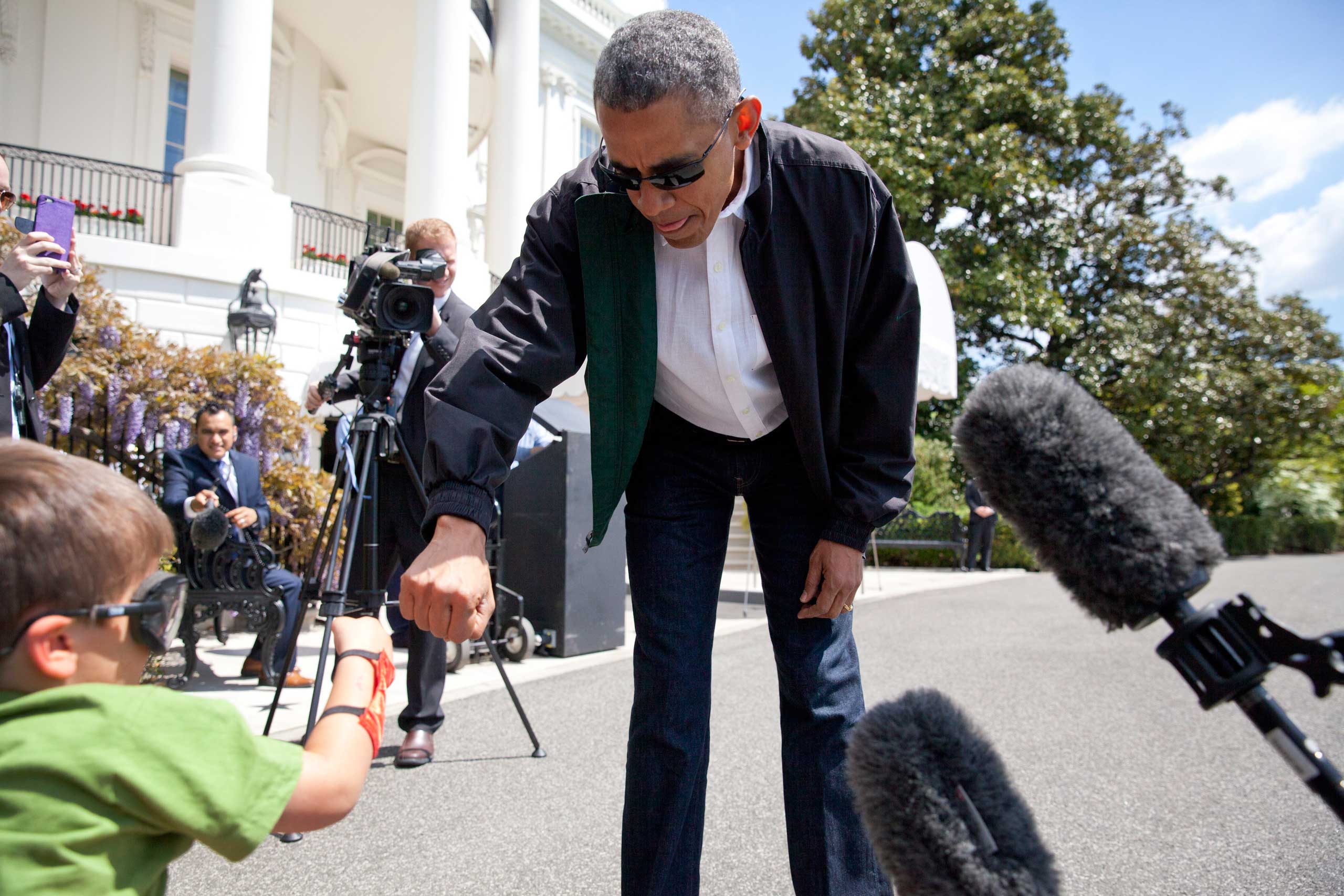 President Barack Obama greets Luca Martinez, 4, with a fist-bump as he walks from the White House to board Marine One in Washington on May 2, 2015. (Carolyn Kaster—AP)