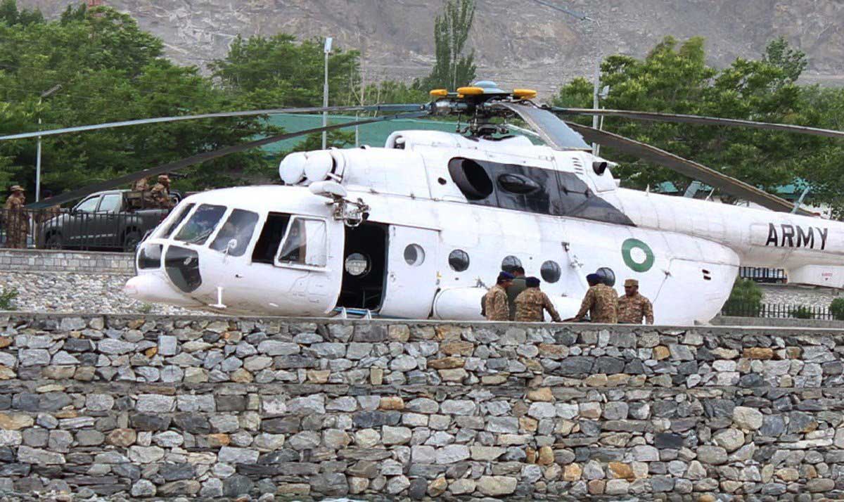 Pakistani soldiers gather beside an army helicopter at a military hospital where victims of a helicopter crash were brought for treatment in Gilgit, Pakistan on May 8, 2015. (Farman Karim—AFP/Getty Images)