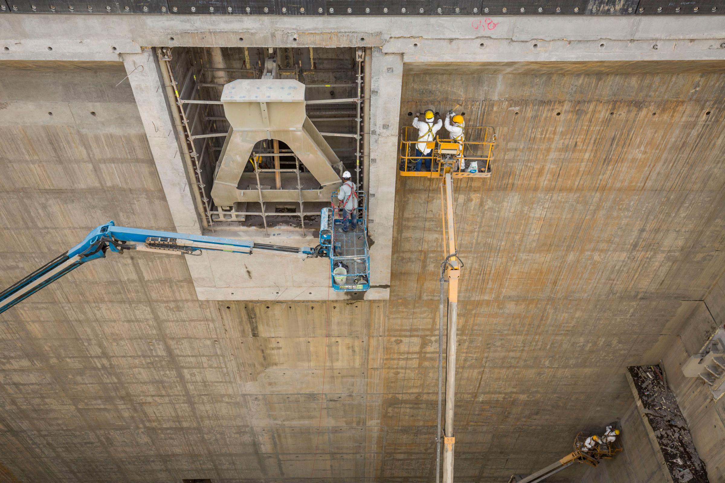 Workers make final refinements to the concrete and steel slot that will hold the last gate on the Pacific side of the Panama Canal Expansion project . April 23, 2015.