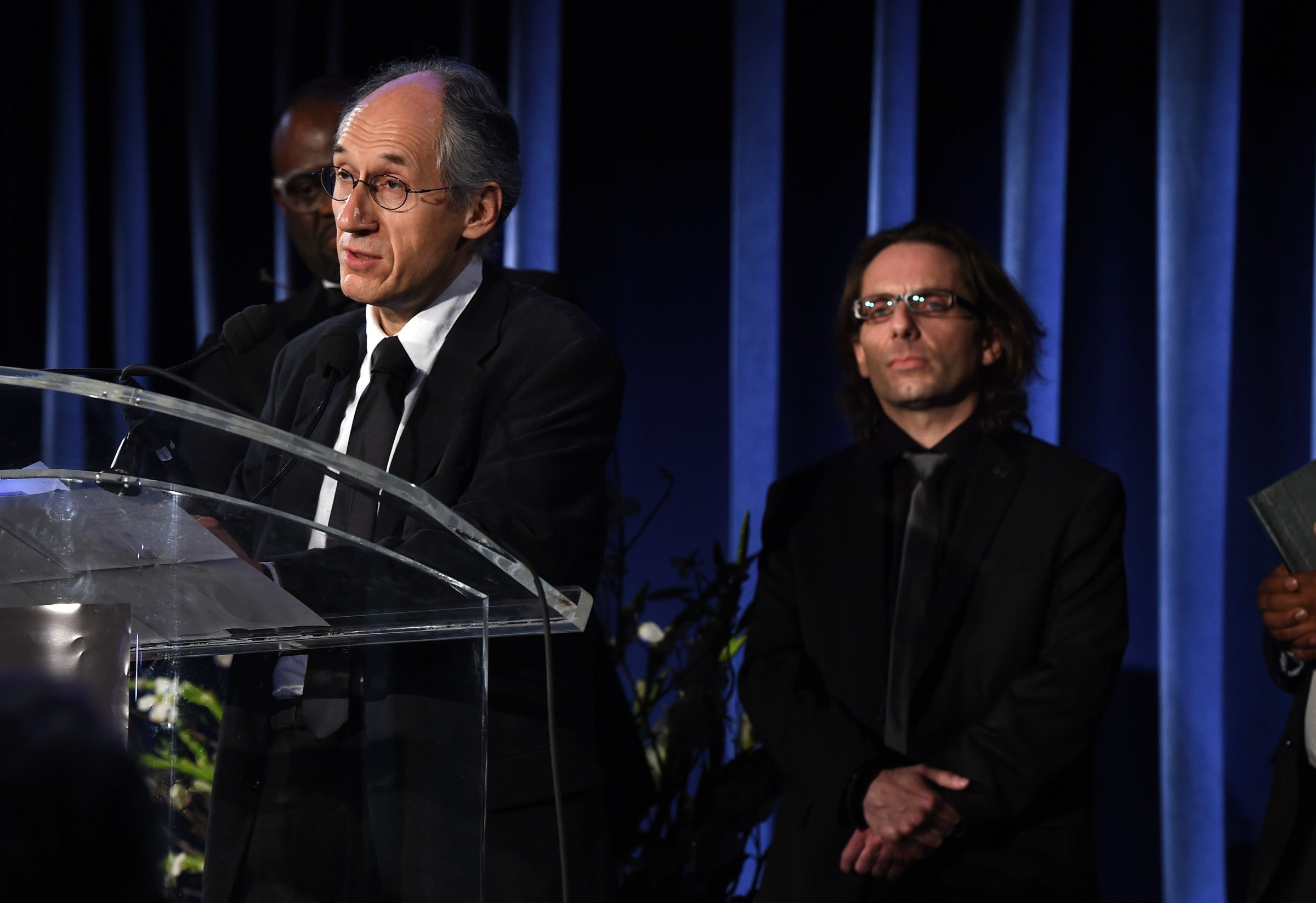 Gerard Biard (L), editor-in-chief of the Paris-based satirical weekly Charlie Hebdo, speaks before critic Jean-Baptiste Thoret (R) during the annual PEN American Center Literary Gala May 5, 2015 at the American Museum of Natural History in New York.