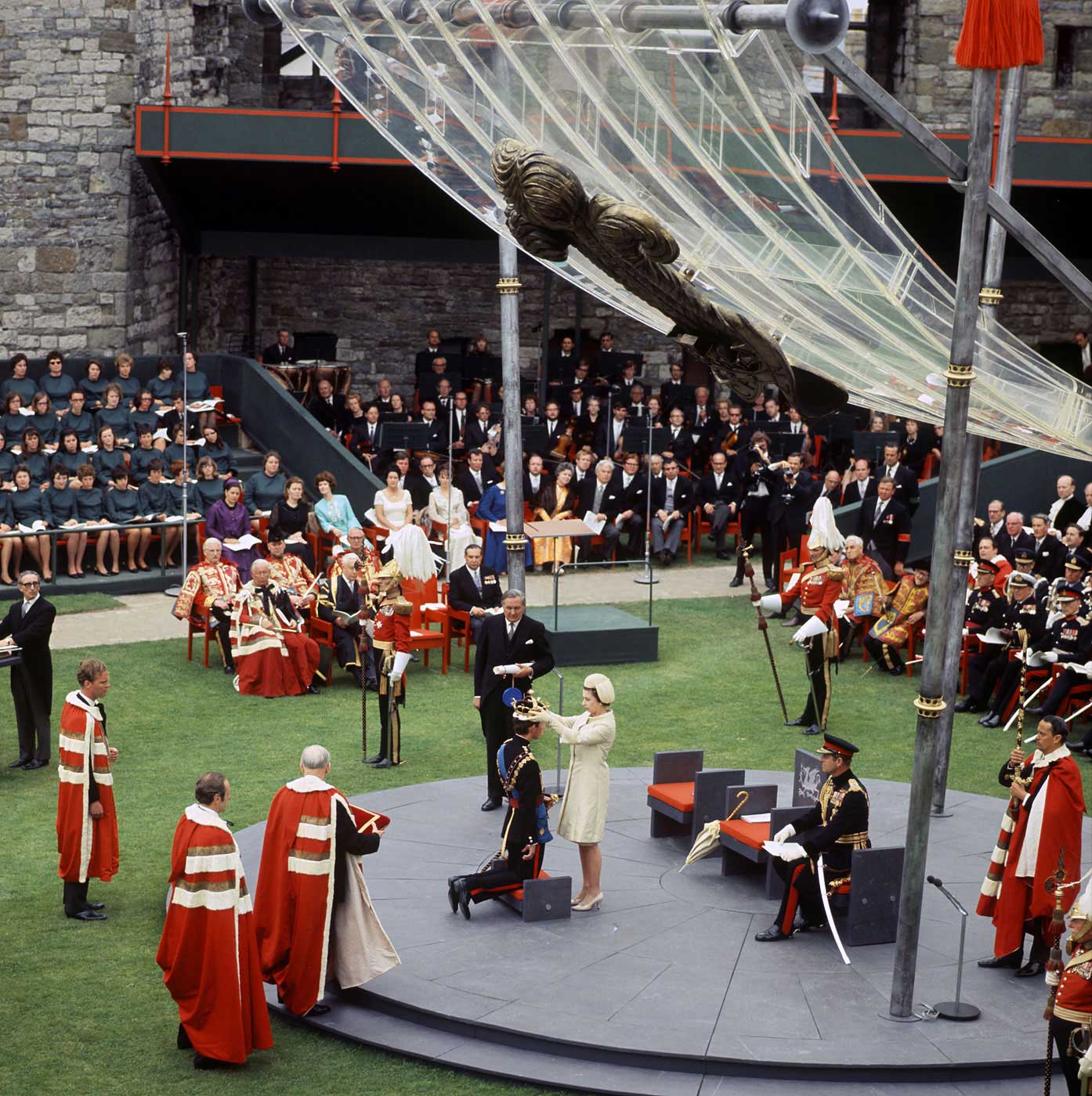 Prince Charles kneels before his mother at Caernarvon Castle on July 1, 1969, during his investiture as the 21st Prince of Wales and Earl of Chester. The title is reserved for the heir apparent to the throne. Charles is the oldest and longest-serving holder of the title.